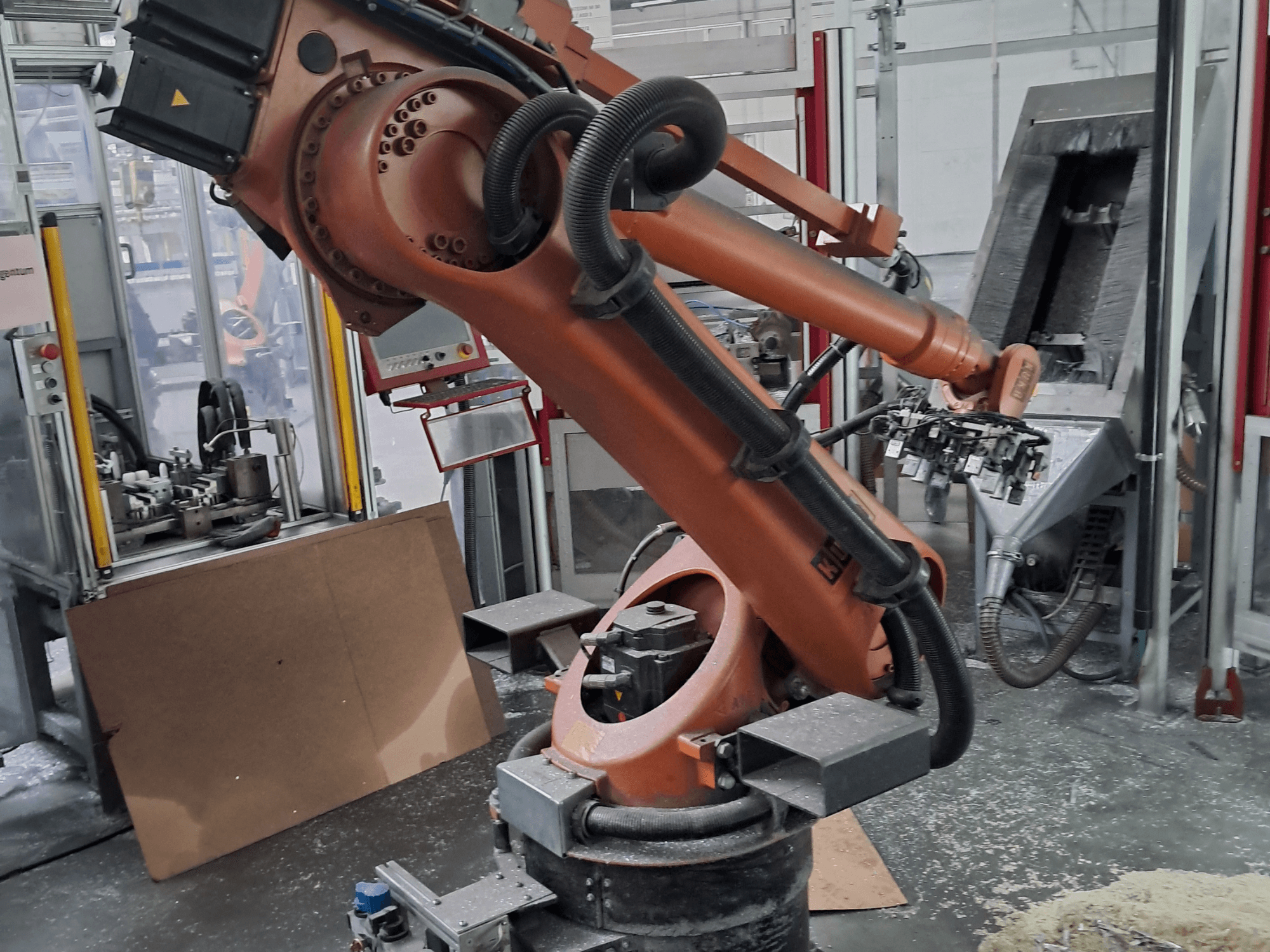 KUKA KR 30 L 16-2 robot arm in a workshop, front view. Features articulated joints and an industrial workspace background.