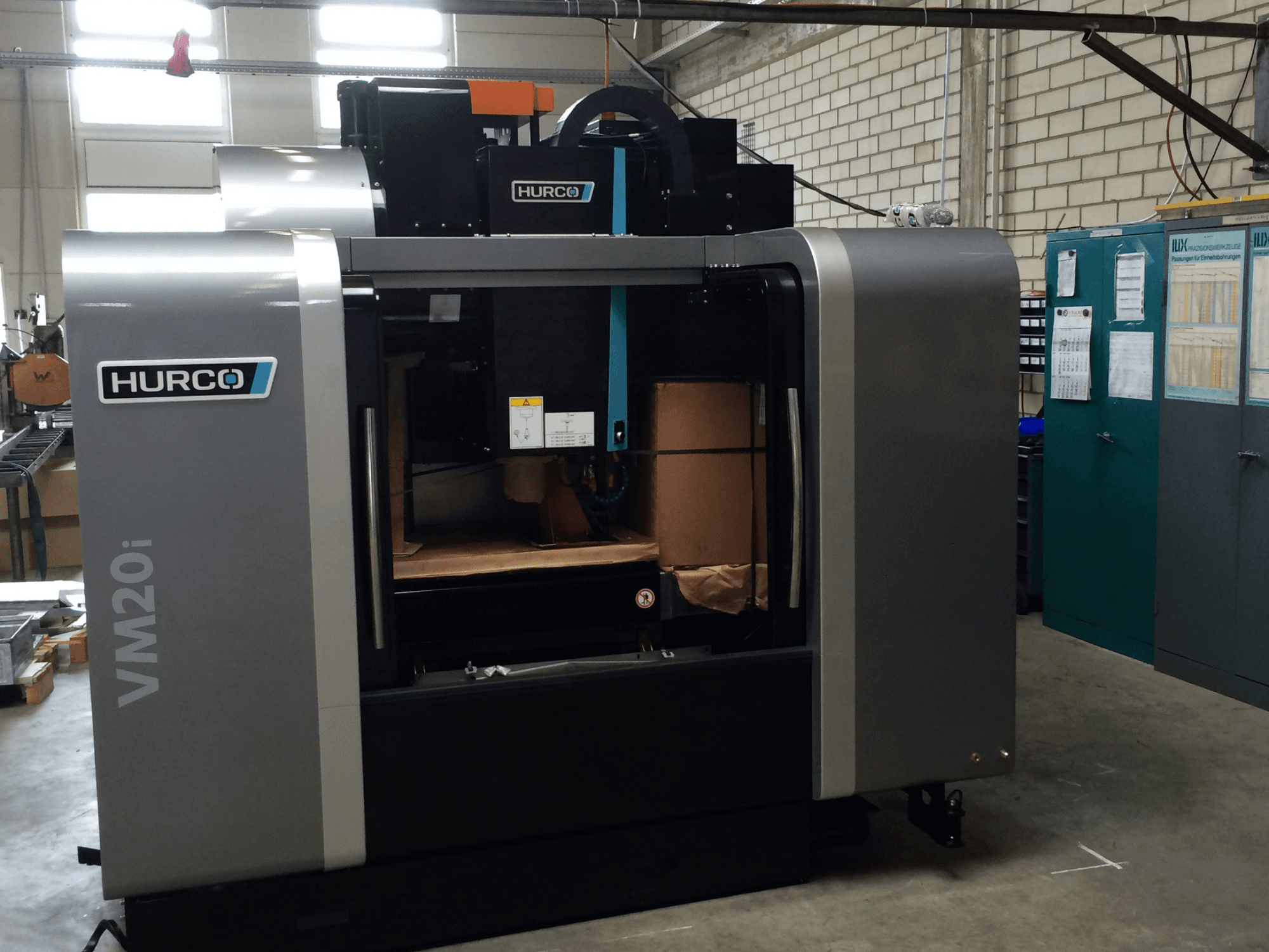 Hurco VM20i vertical machining center, front view, showcasing design, control panel, and open tooling area.