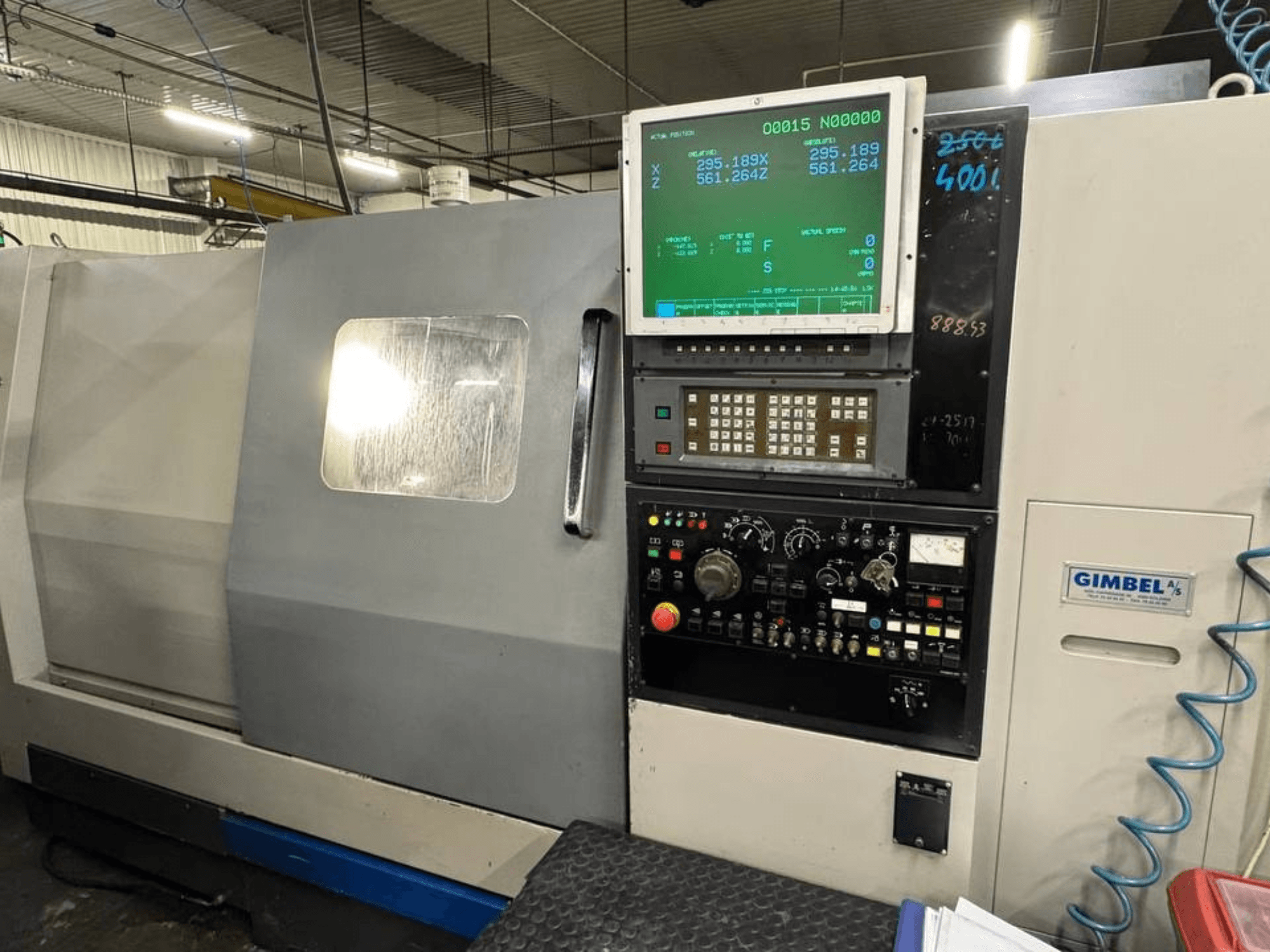 Front view of Takisawa TS-35 horizontal turning machine, featuring control panel with digital display and operation controls.
