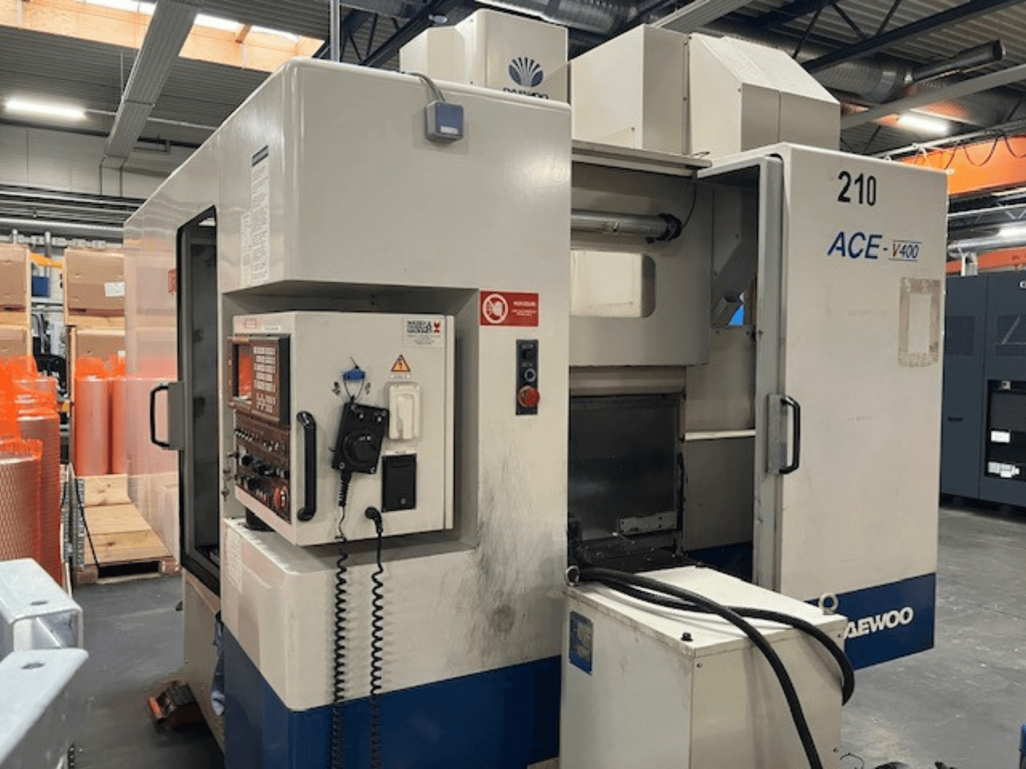 Daewoo ACE-V400 CNC machine in a side view, featuring control panel, coolant tank, and open work area.