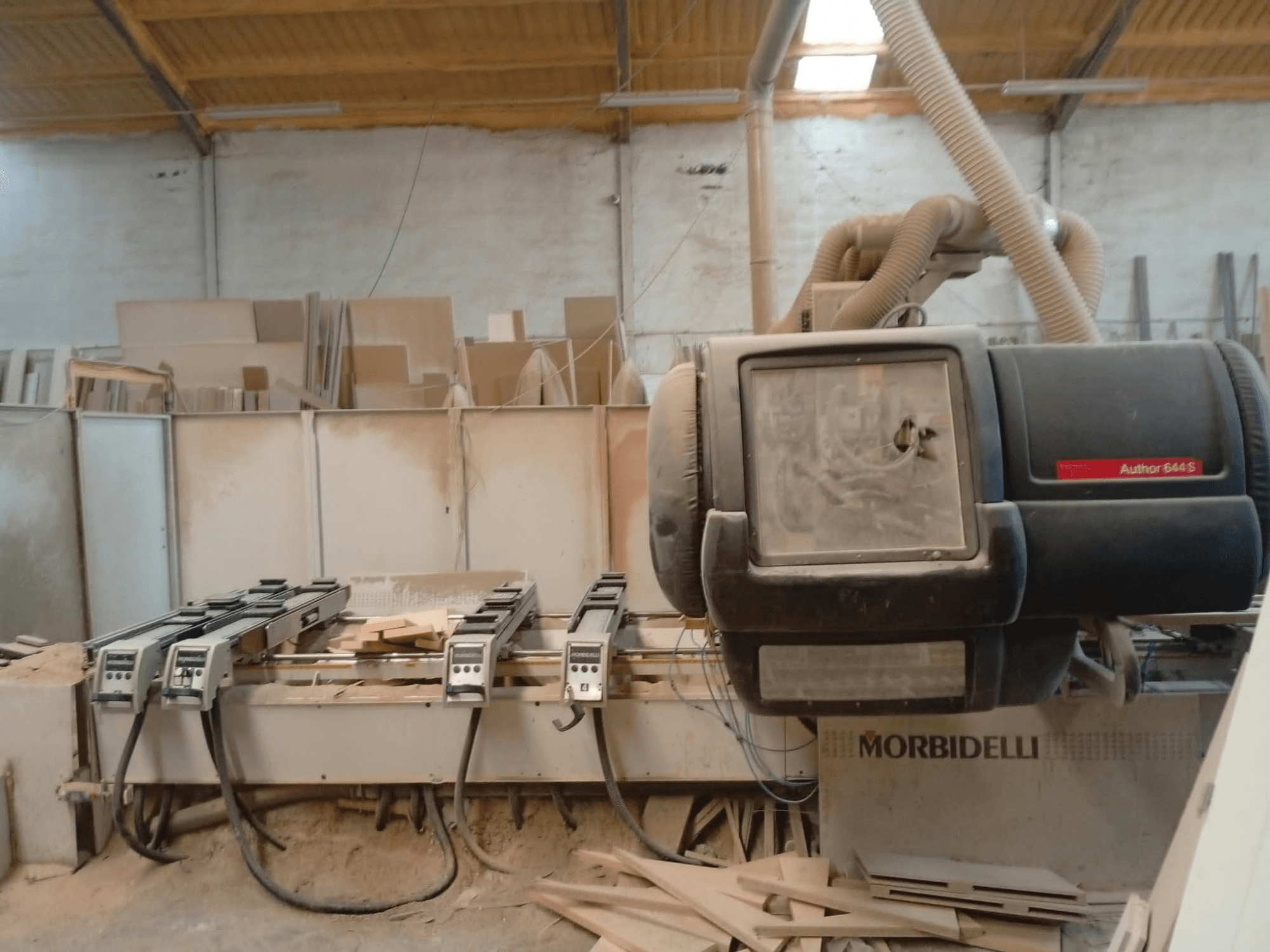 CNC Processing Center MORBIDELLI A644S FTP 41 PC displayed in a workshop, showing front view with dust and wood debris.