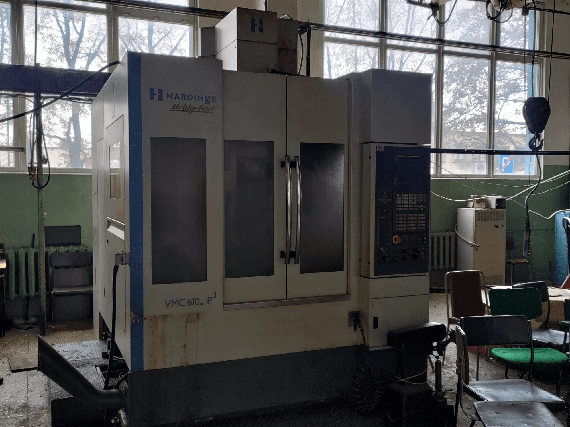 Bridgeport VMC-610 XP3 vertical machining center from a front view, showcasing control panel and large glass doors.