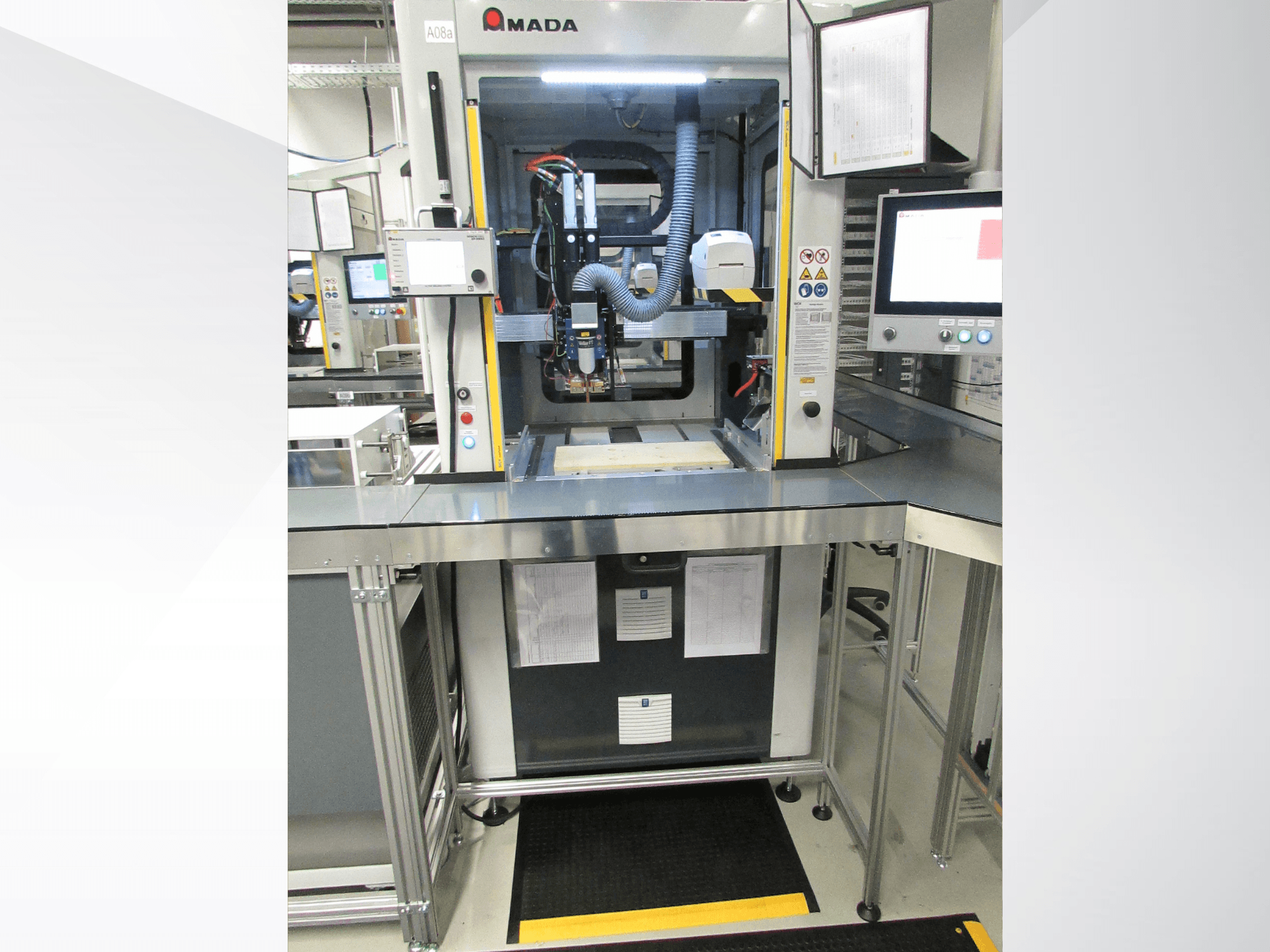 Front view of AMADA Jupiter System automation machine with controls, monitor, and clear workspace for operation.