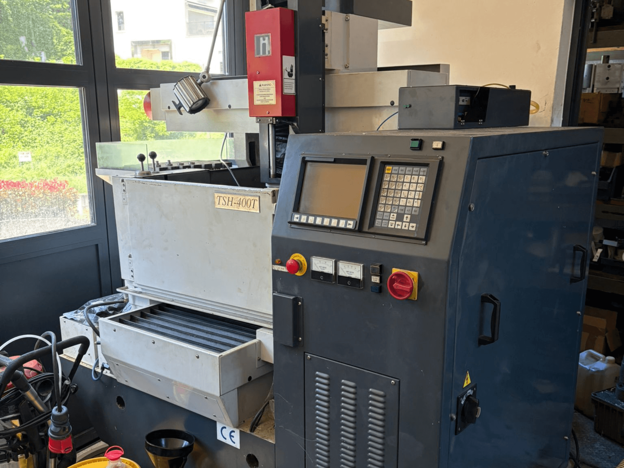 Top view of TOPEDM TSH-400T die-sinking EDM machine, showcasing control panel and working area. Suitable for precision tasks.