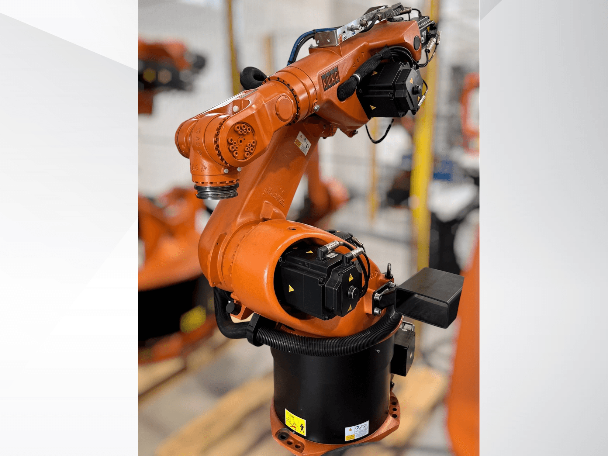 KUKA KR 60-3 robot arm in orange; side view showing base, joints, and control modules for automation tasks.