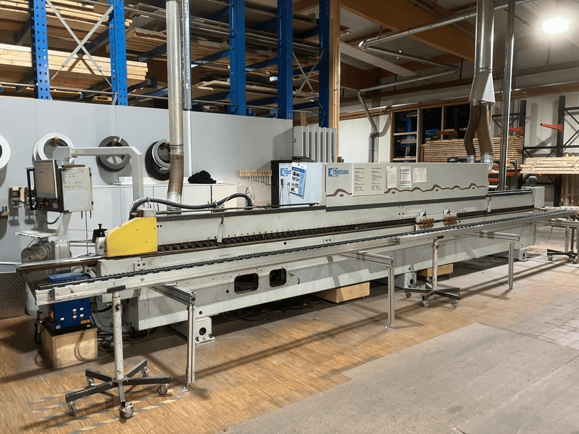 HOMAG Optimat KL 78/A20/S2 edgebander in side view, featuring control panel, conveyor, and dust extraction system.
