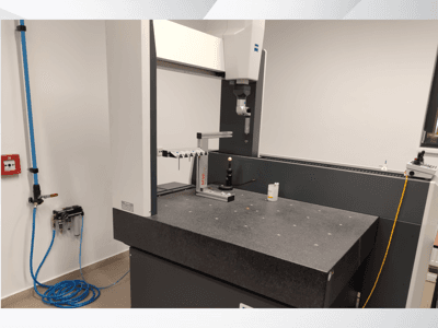 MSR measurement device in a lab, front view showcasing a granite table, calibration sphere, and connected utilities.