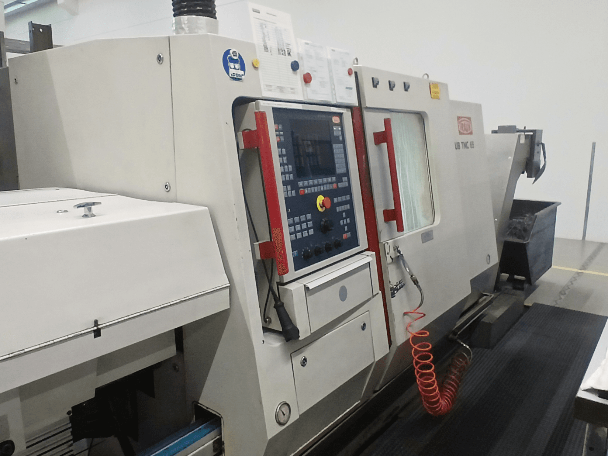 Horizontal turning machine TRAUB TNC65 DG, front view, showing control panel and tools, ideal for precision machining.
