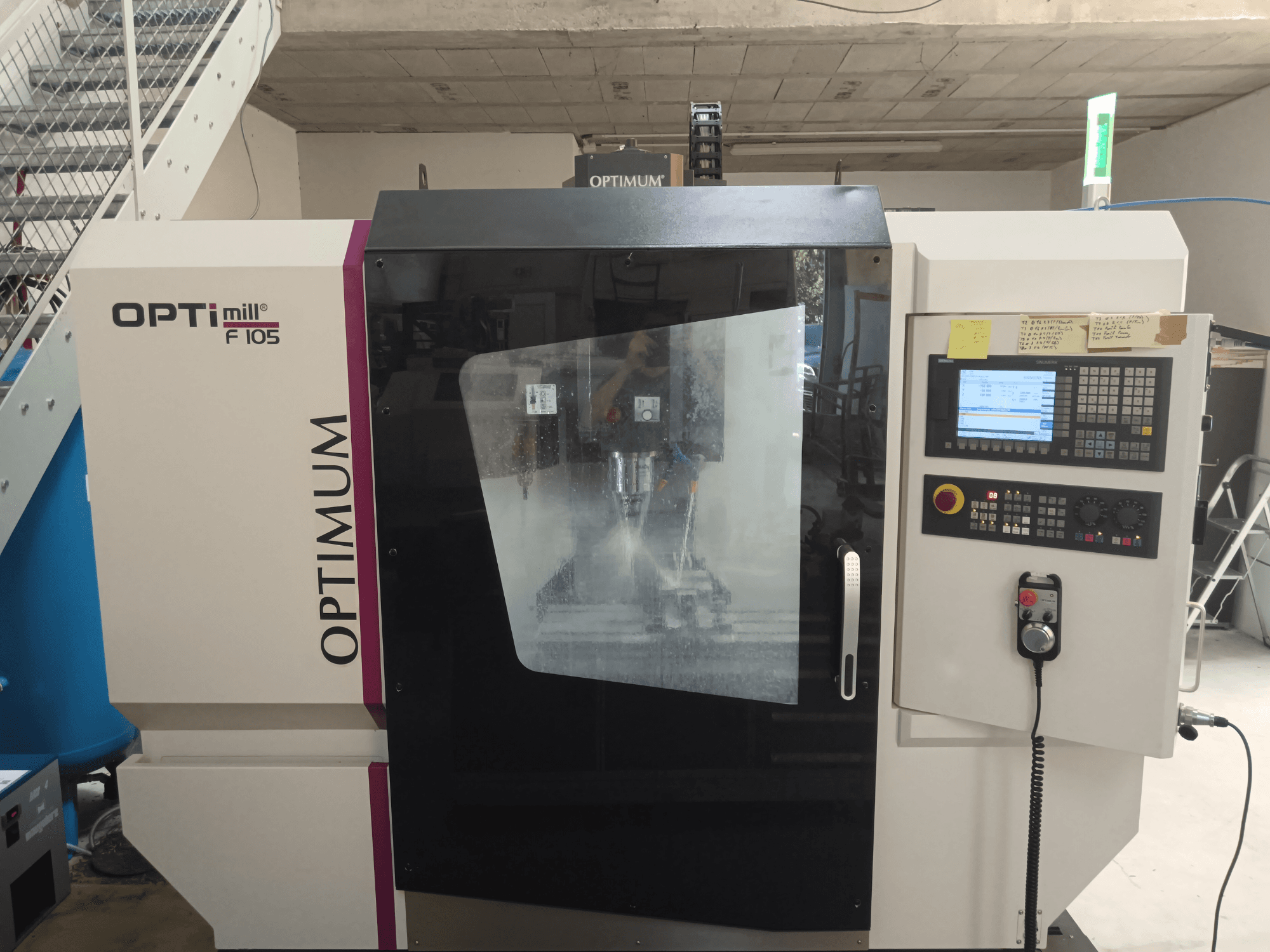 Front view of the Optimum Optimill F 105 vertical machining centre, featuring a control panel and clear viewing window.
