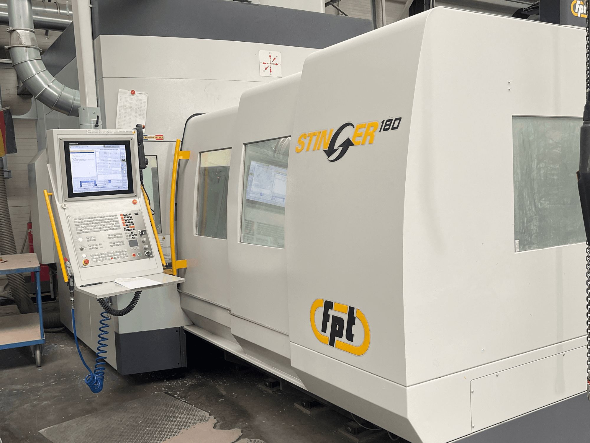 Front view of FPT STINGER 180 vertical machining center, showcasing control panel and machine features.