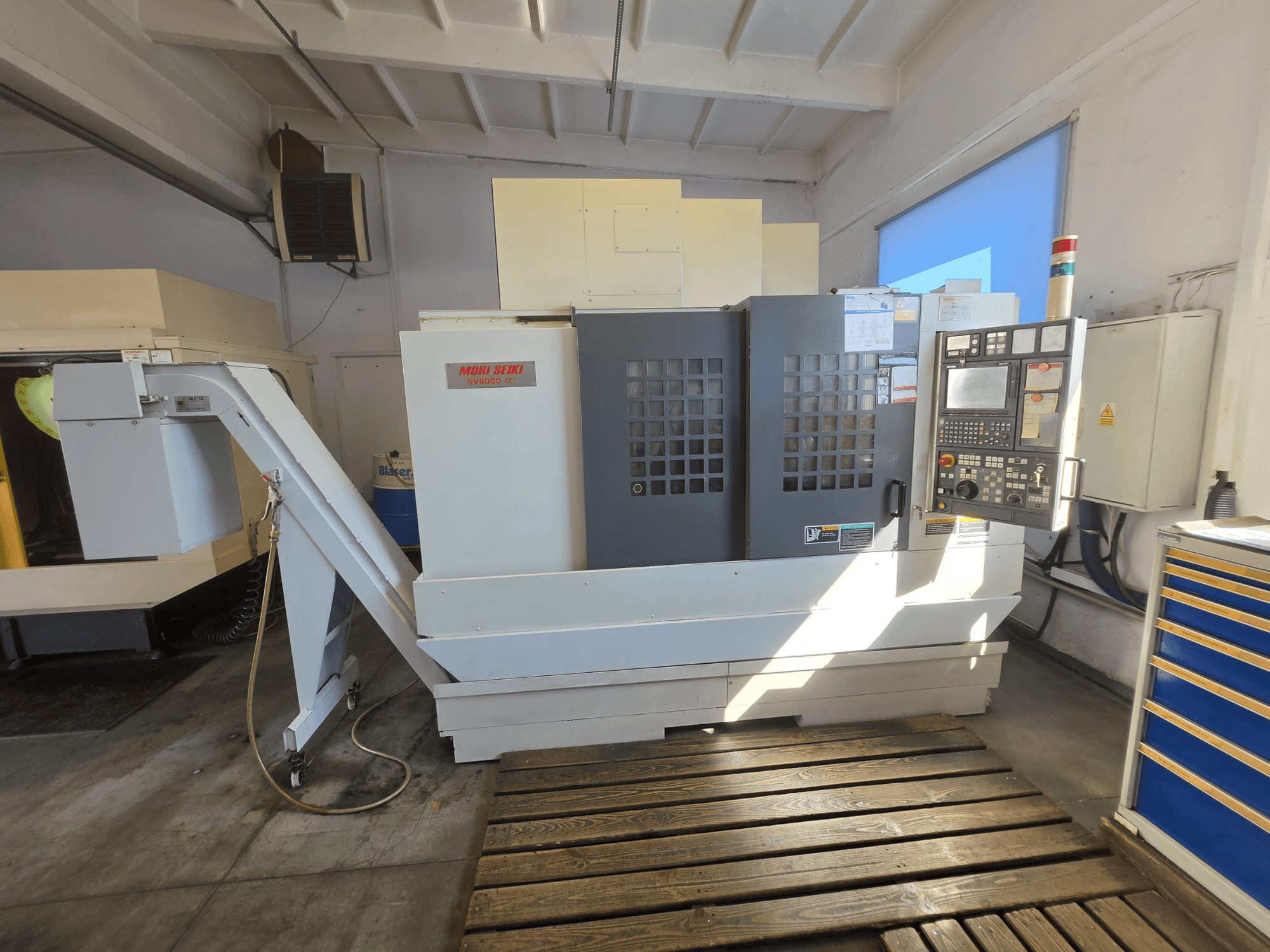 MORI SEIKI NV 5000 alpha1 Vertical Machining Centre, front view showing control panel and machine features in a workshop setting.