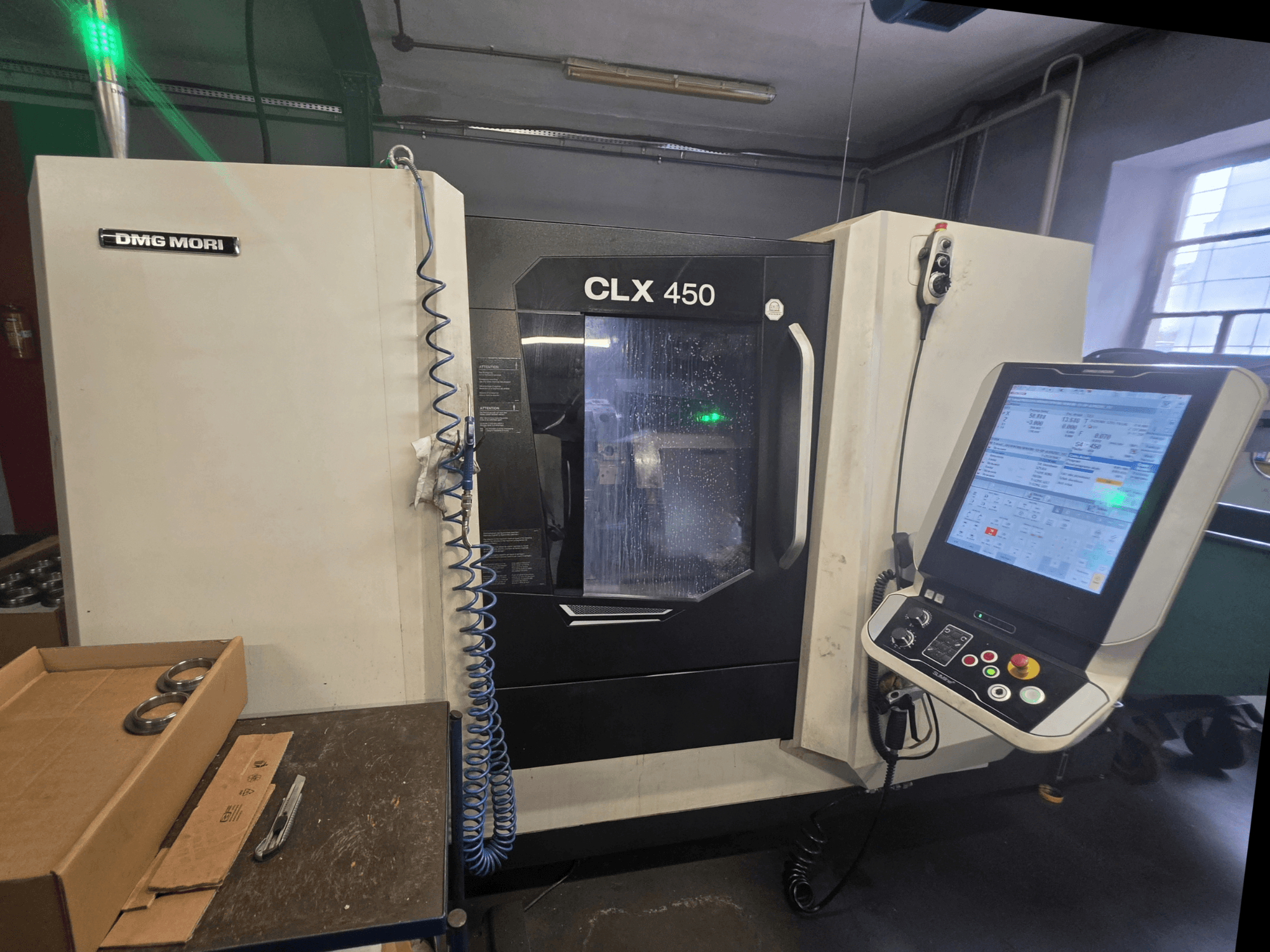 DMG MORI CLX 450 V3 horizontal turning machine front view featuring control panel, coolant system, and work area.