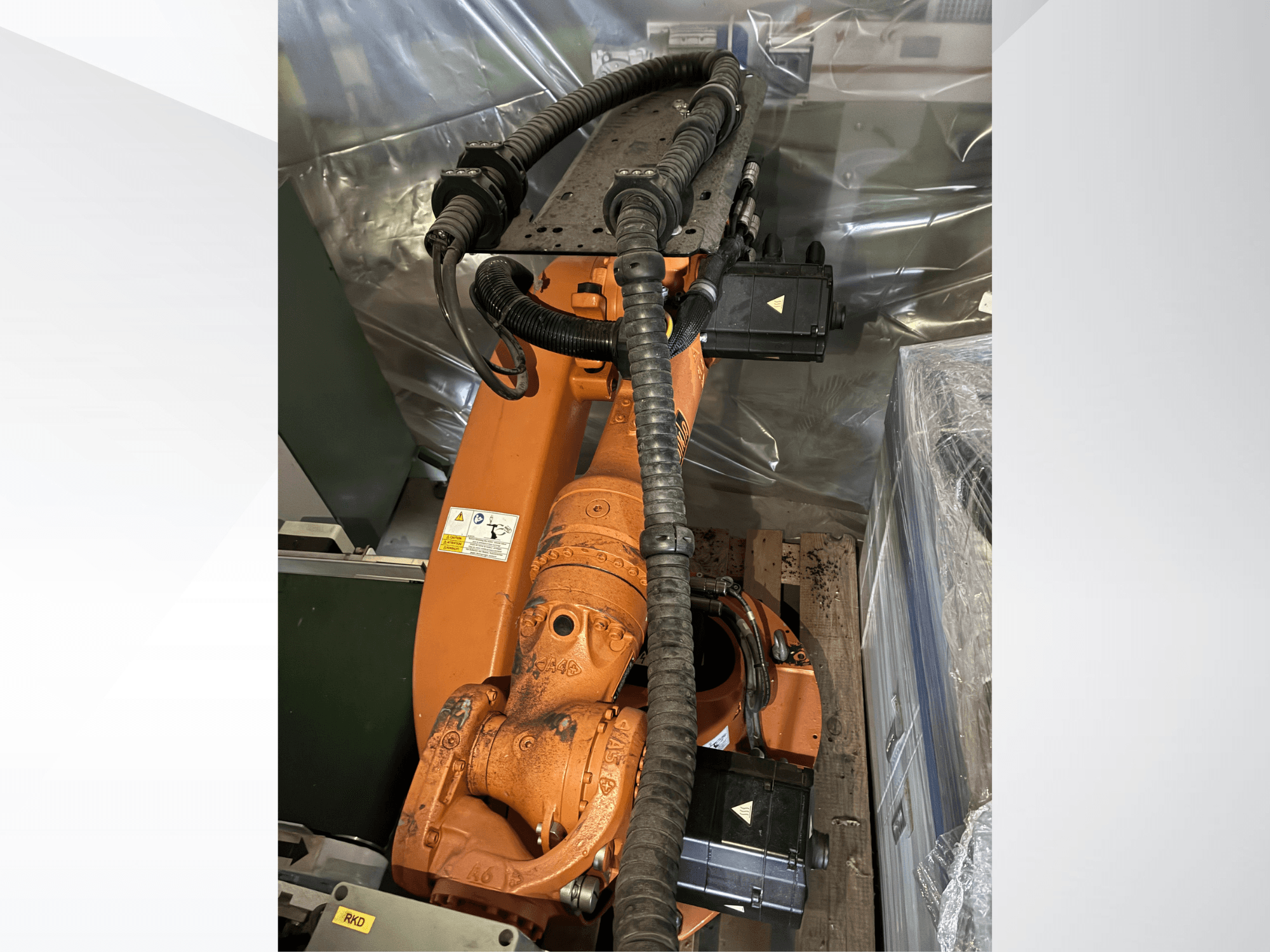 KUKA KR16-2 robot arm in orange, viewed from above, showcasing connectors and protective tubing.