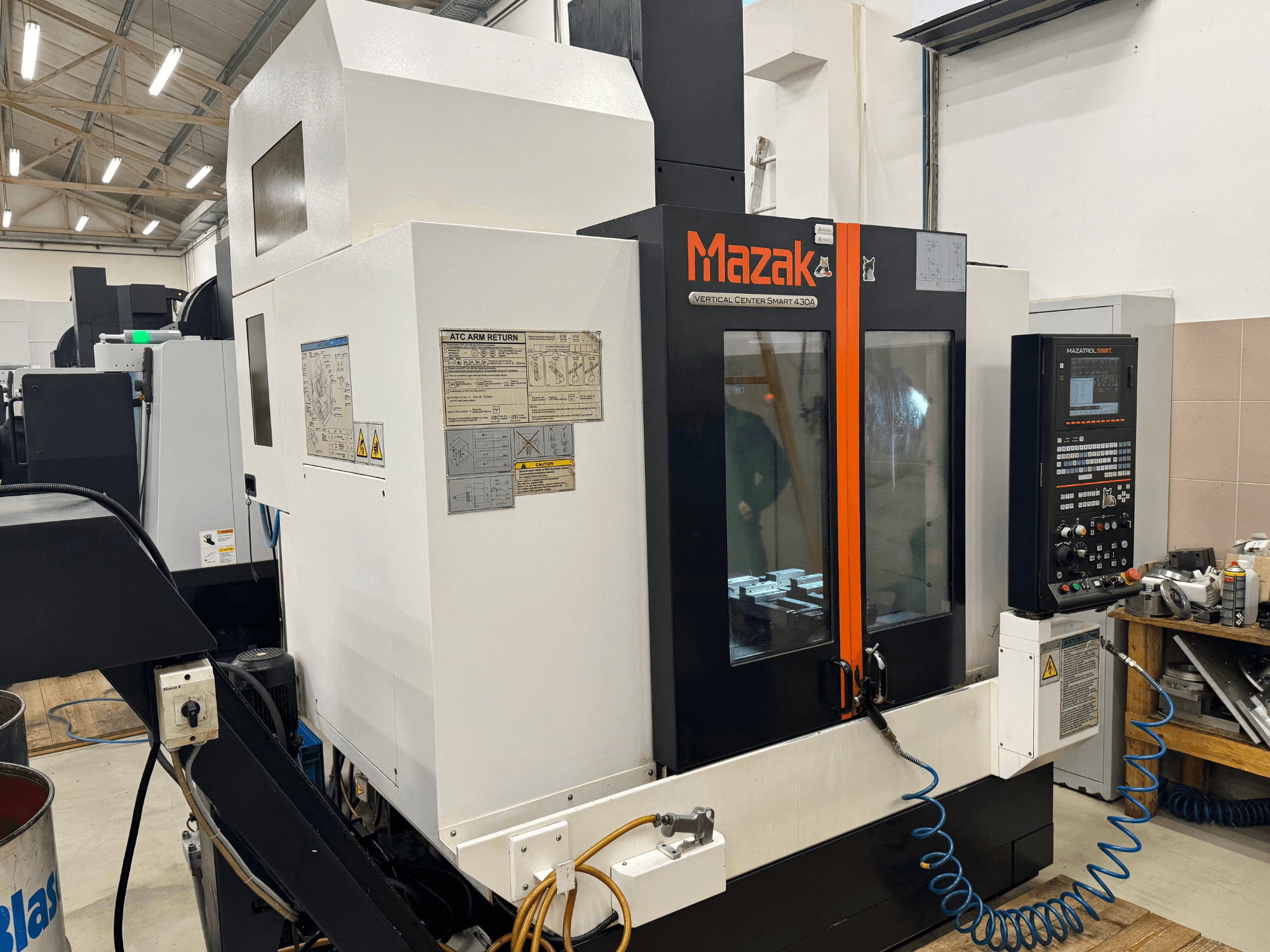 Mazak Vertical Center Smart 430A, front view; CNC milling machine with control panel, clear enclosure, and tool holder visible.