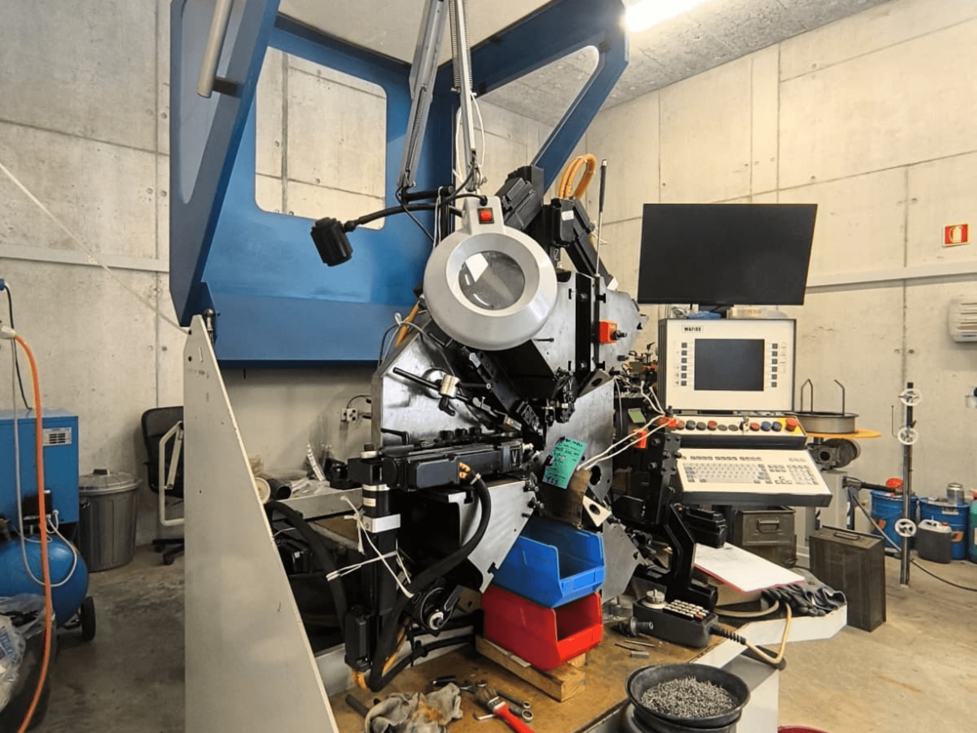 WAFIOS Fmu1 sheet metal machine in front view, showcasing controls and components, set in an industrial workspace.