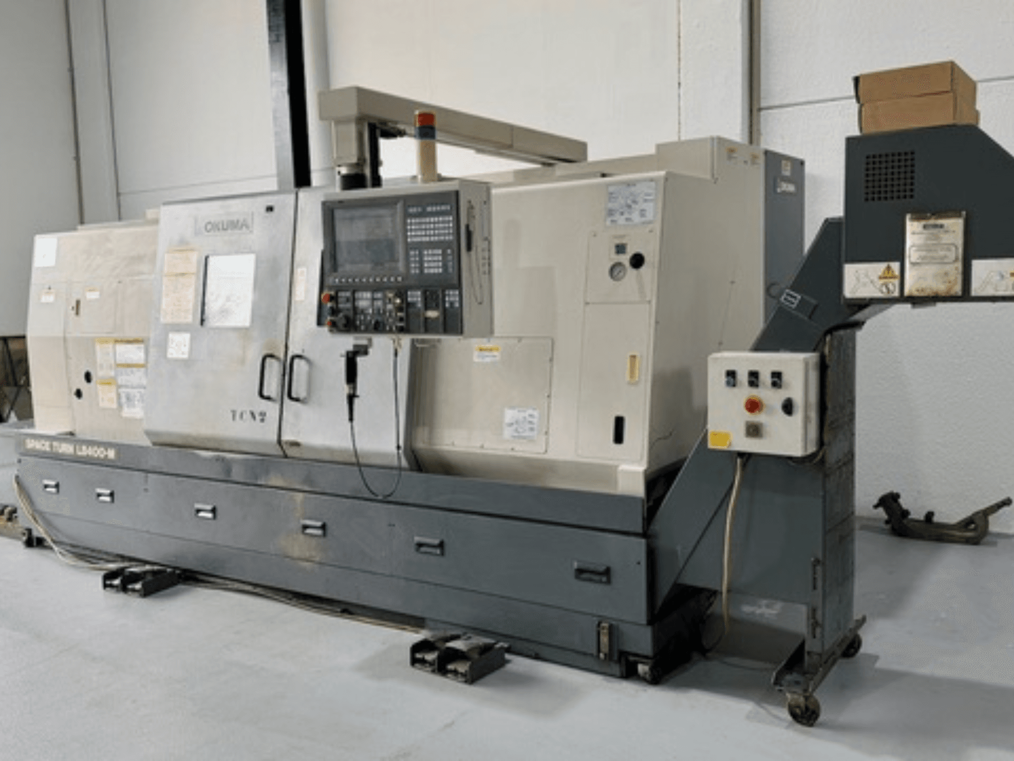Okuma Space Turn LB400-M lathe machine, front view with control panel, featuring multiple switches and detailed specifications.