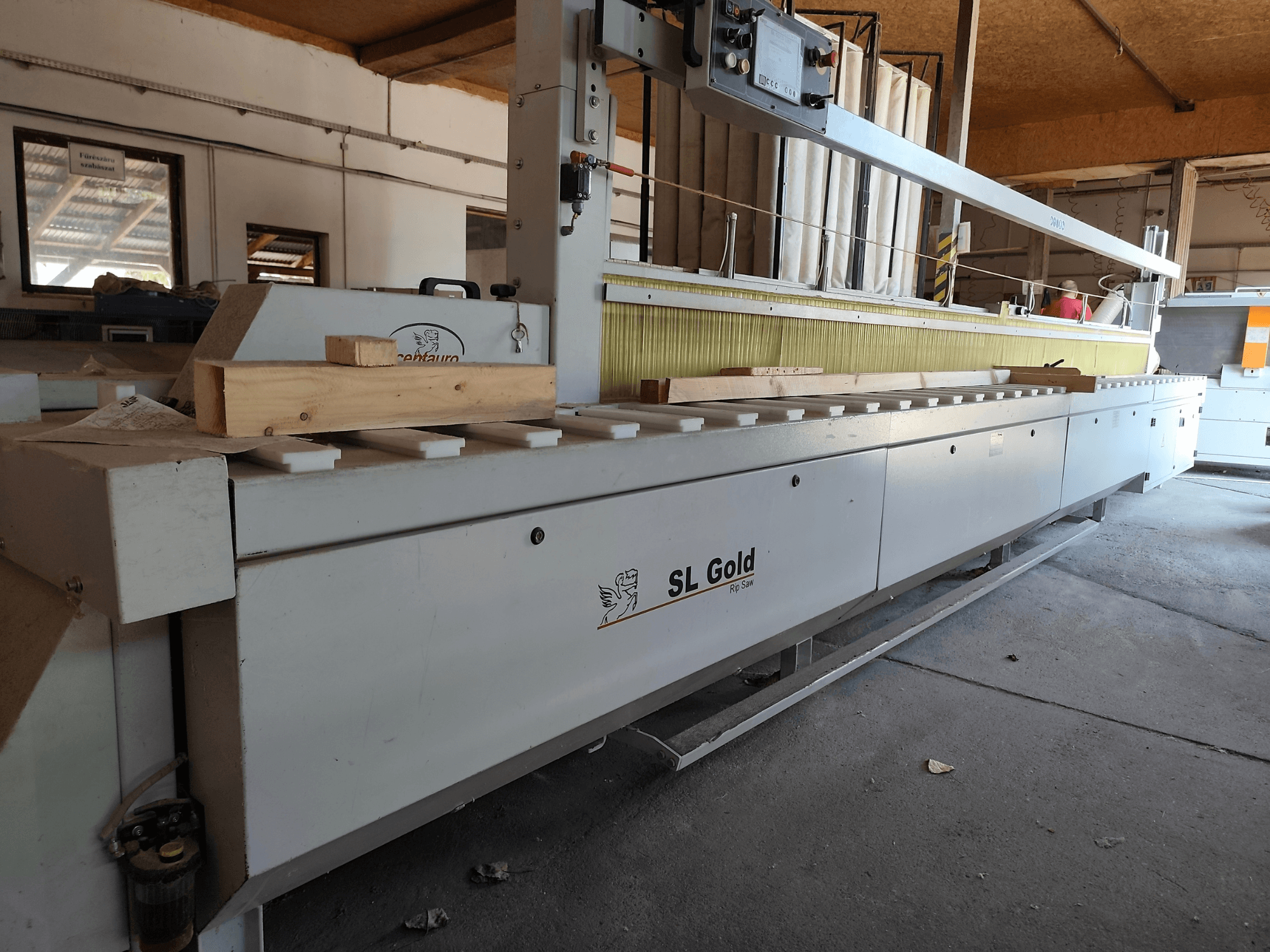Circular wood saw CENTAURO SL Gold 6000, front view, with a wooden piece on the work surface and operational controls visible.