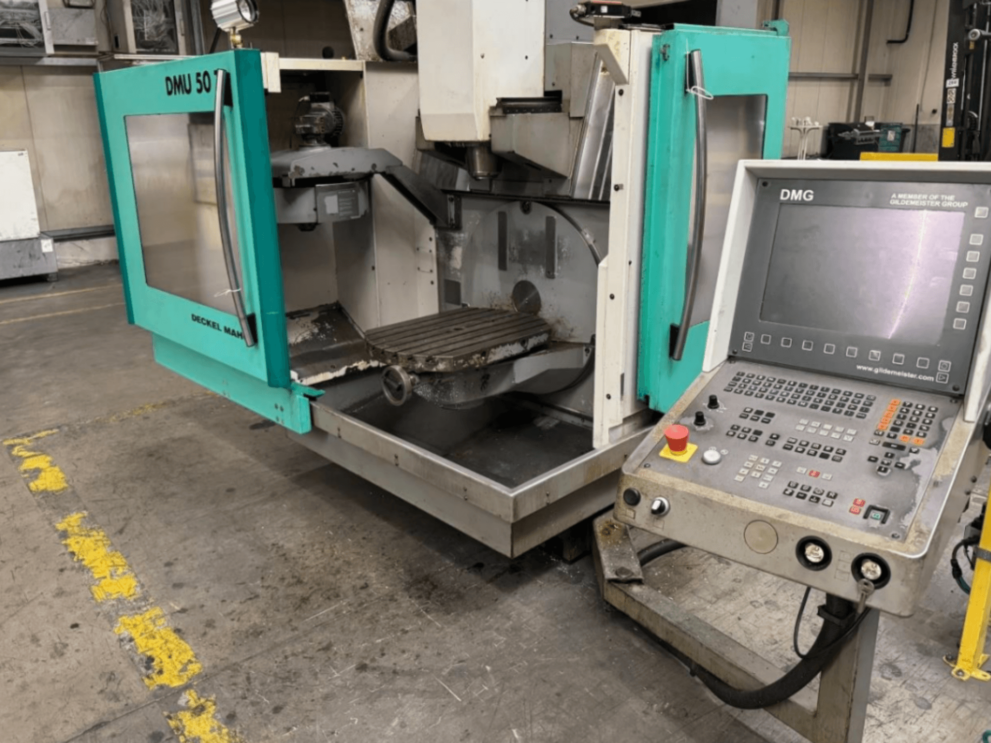 DMG DMU 50 milling machine with open doors showing the interior and control panel, viewed from the front.