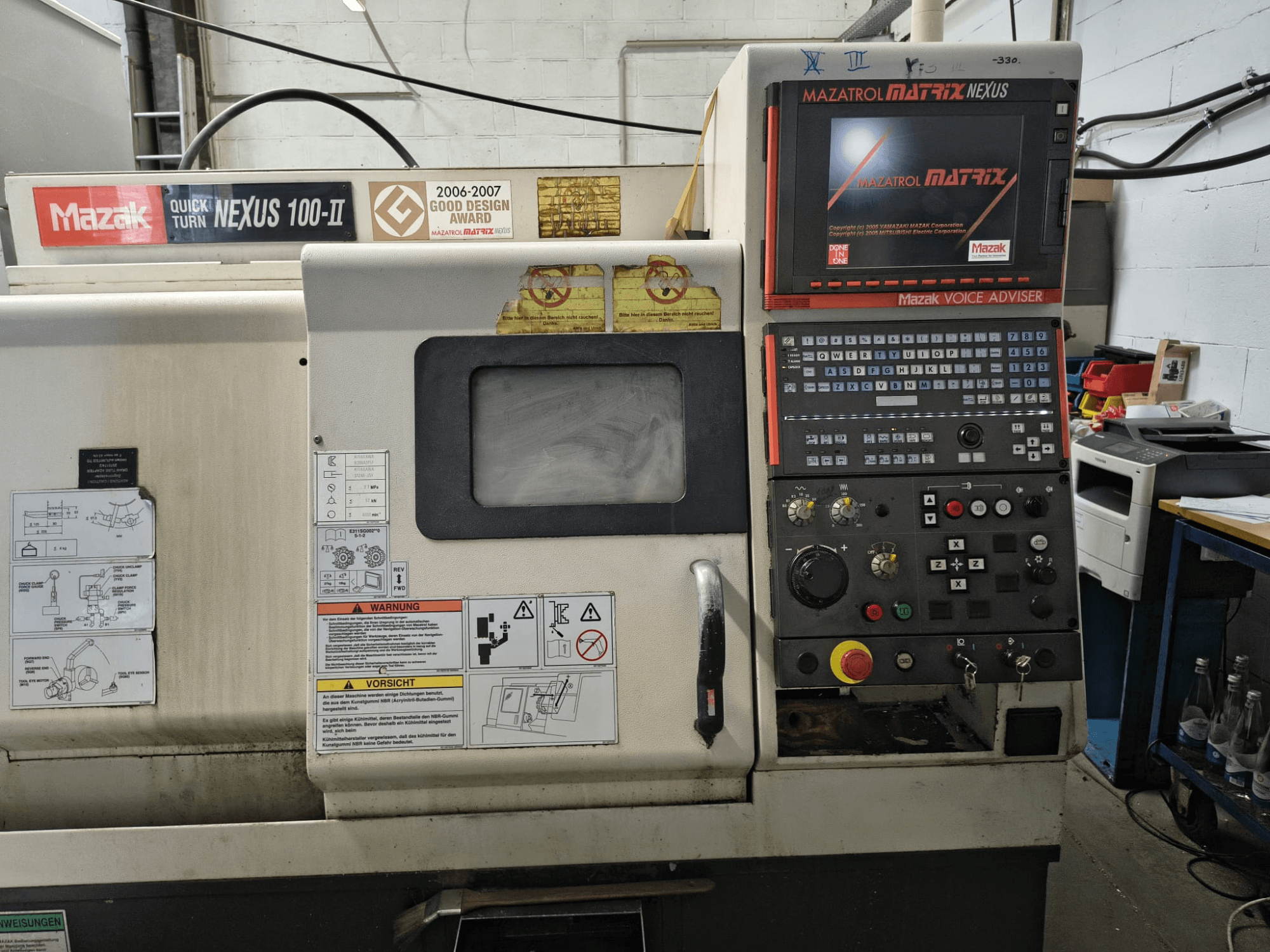 Mazak Quick Turn Nexus 100-II horizontal turning machine front view, featuring control panel and display with technical details.
