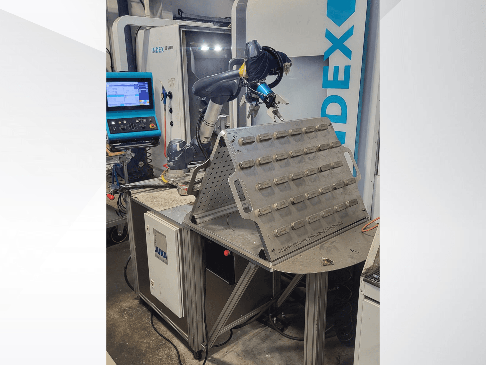 DOOSAN M1013 collaborative robot from a front view, positioned near a worktable with a tool holder and control panel.