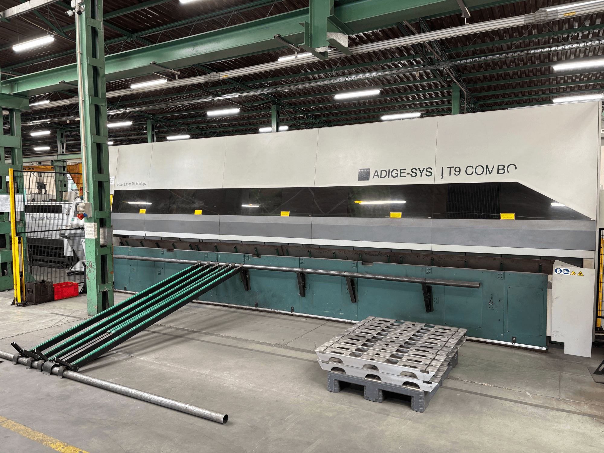 BLM Adige LT9 Combo Tube Cutting Machine front view with green loading arms and pallet on factory floor.
