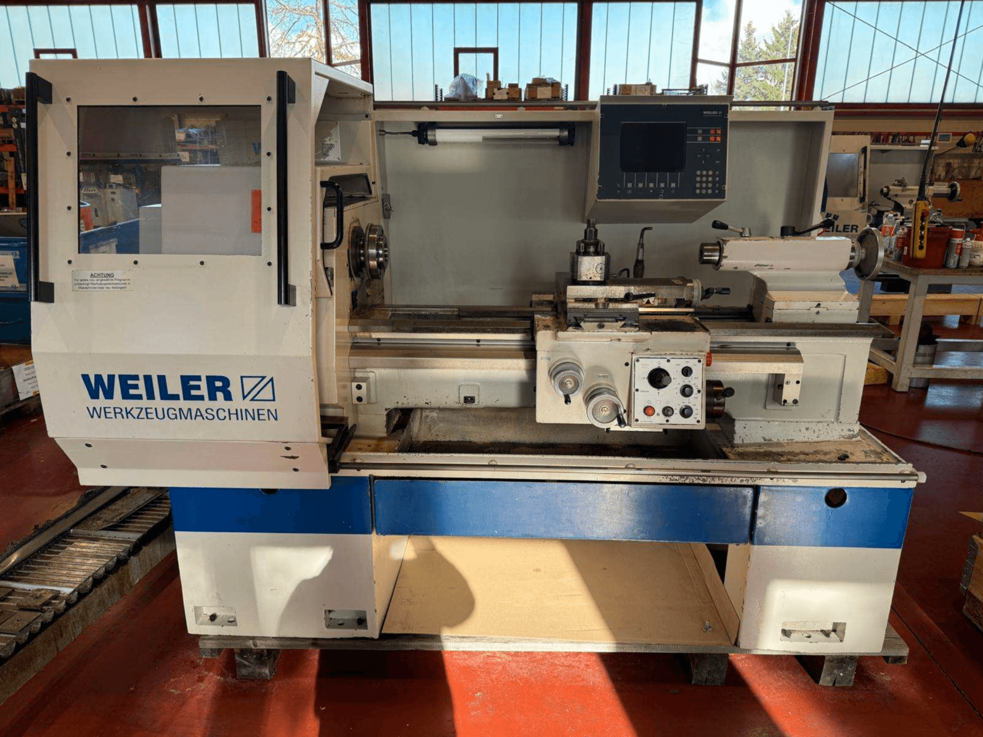Weiler E35 horizontal turning machine in front view, featuring control panel and lathe components.