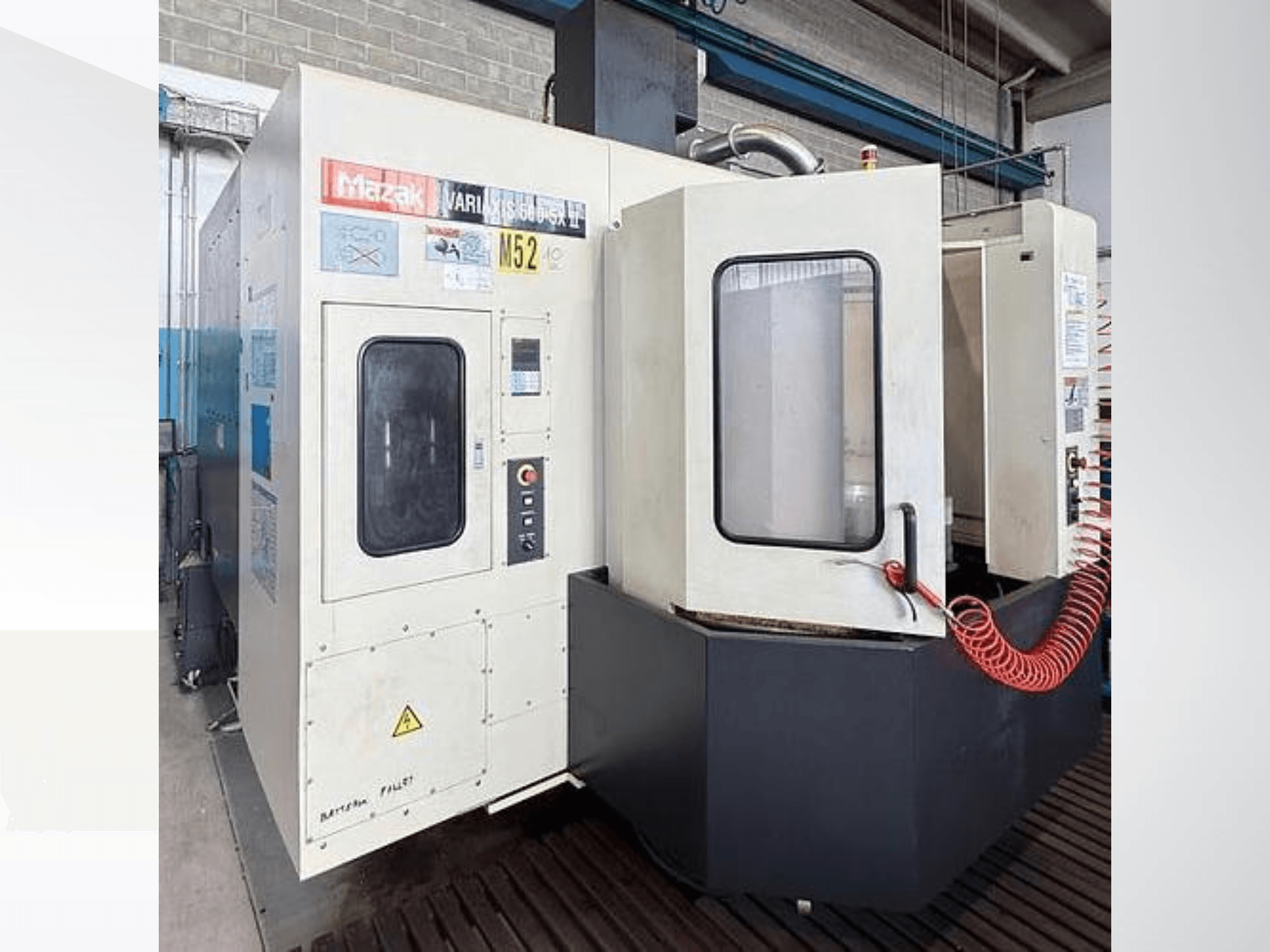 Mazak VARIAXIS500-5XII vertical machining center, front view; featuring a control panel and viewing window.