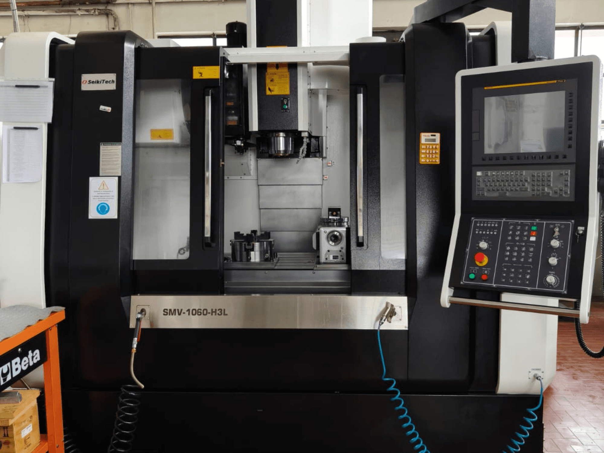 Finetech SMV 1060 H3L vertical machining center, front view showcasing controls, spindle, and parts in machining area.