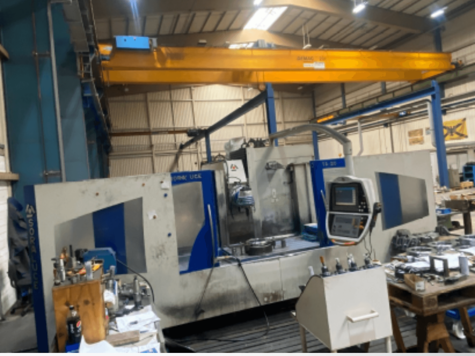 Soraluce TA-20 bed type milling machine in a workshop, featuring a control panel and surrounding tools, shown from a side view.