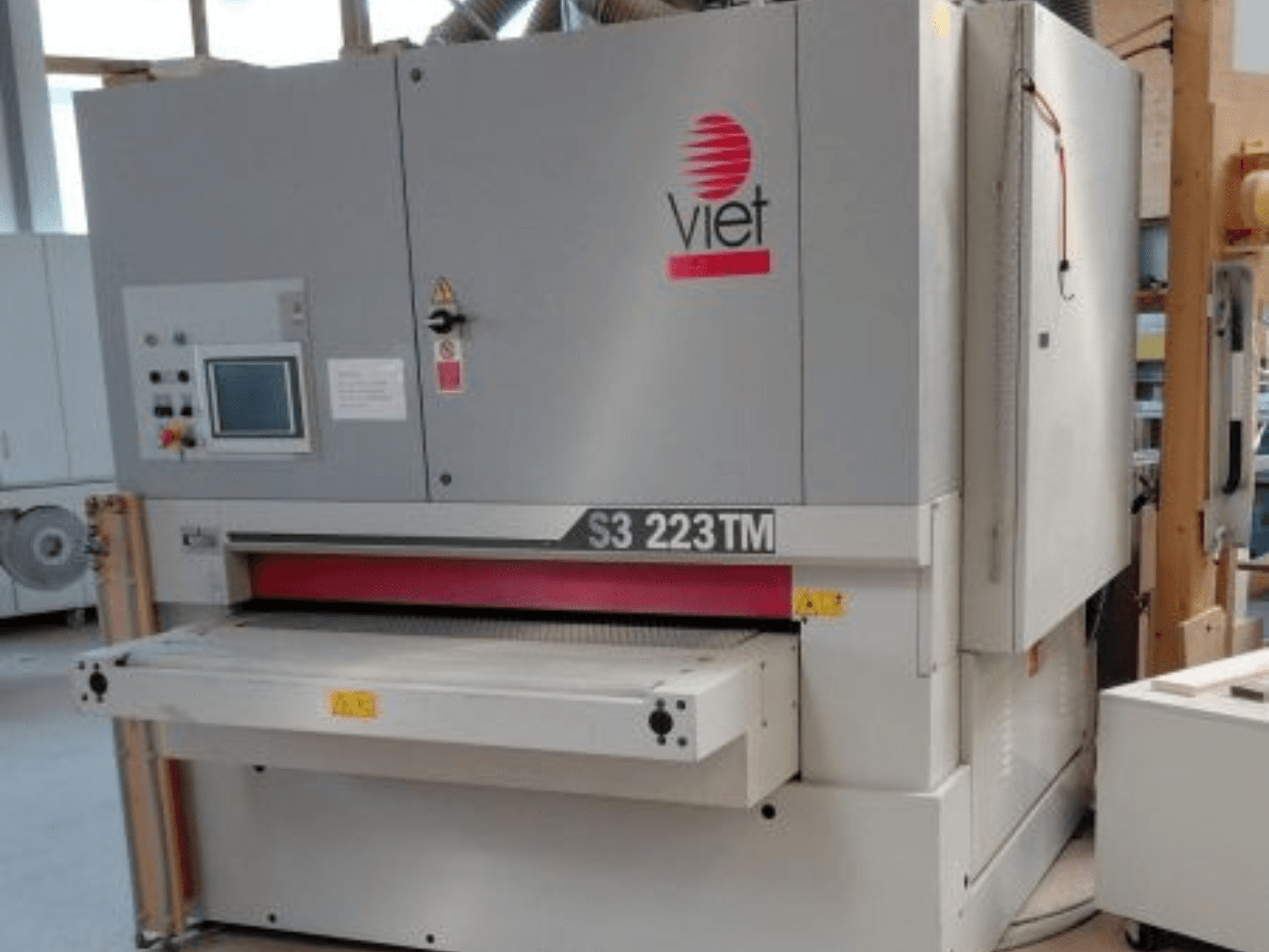 VIET S3 223TM belt sander in a front view, showing control panel, sanding bed, and safety labels.