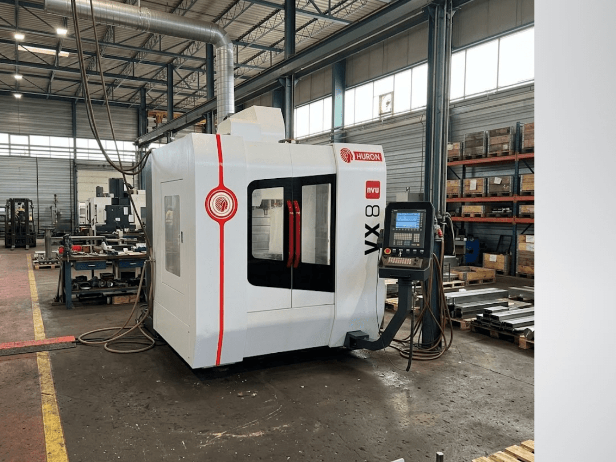 Huron VX 8 vertical machining center in a workshop, front view showcasing its control panel and sleek design.