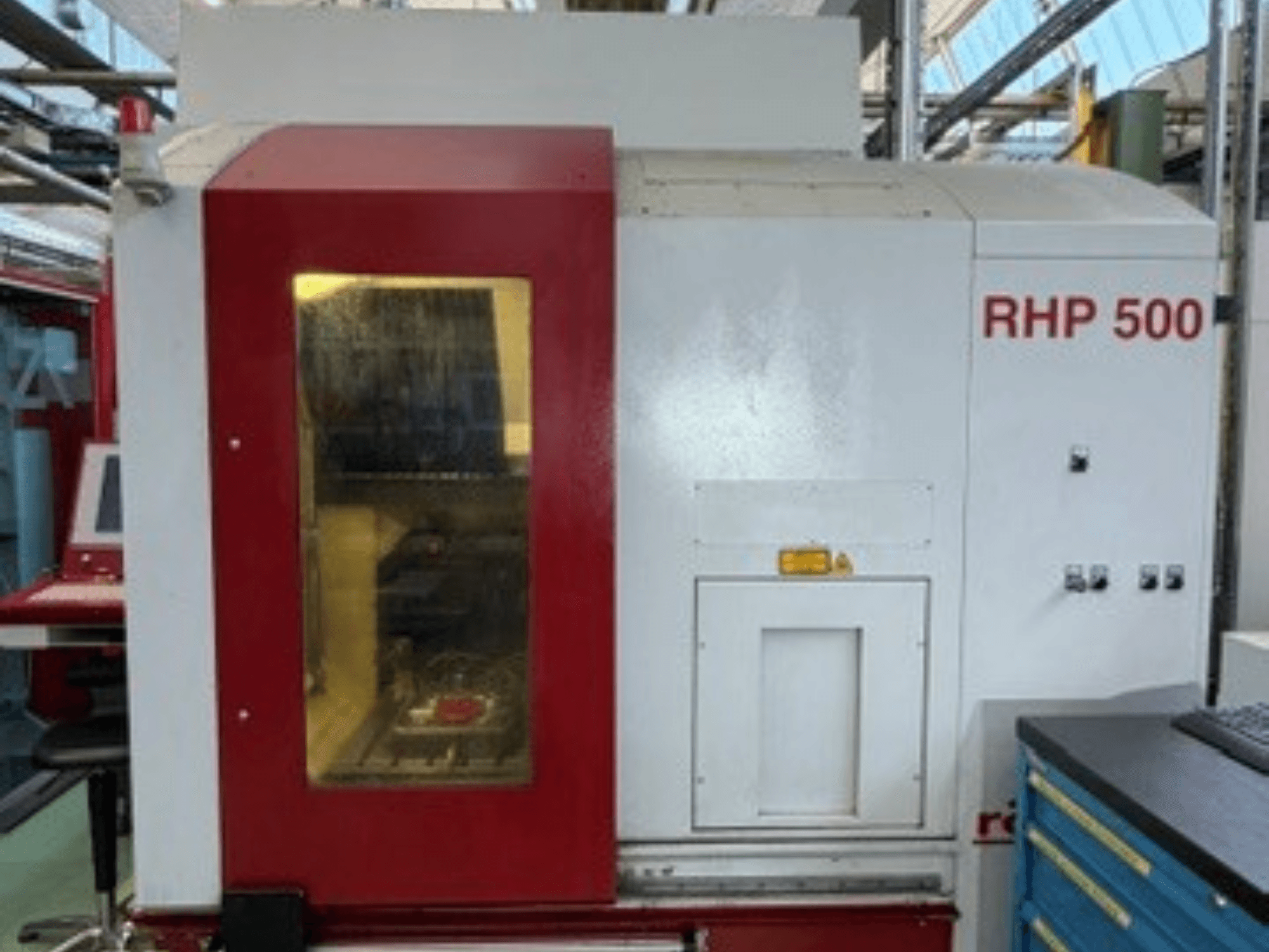 Röders TEC RHP 500 vertical machining center, front view, showcasing control panel and transparent window revealing interior.