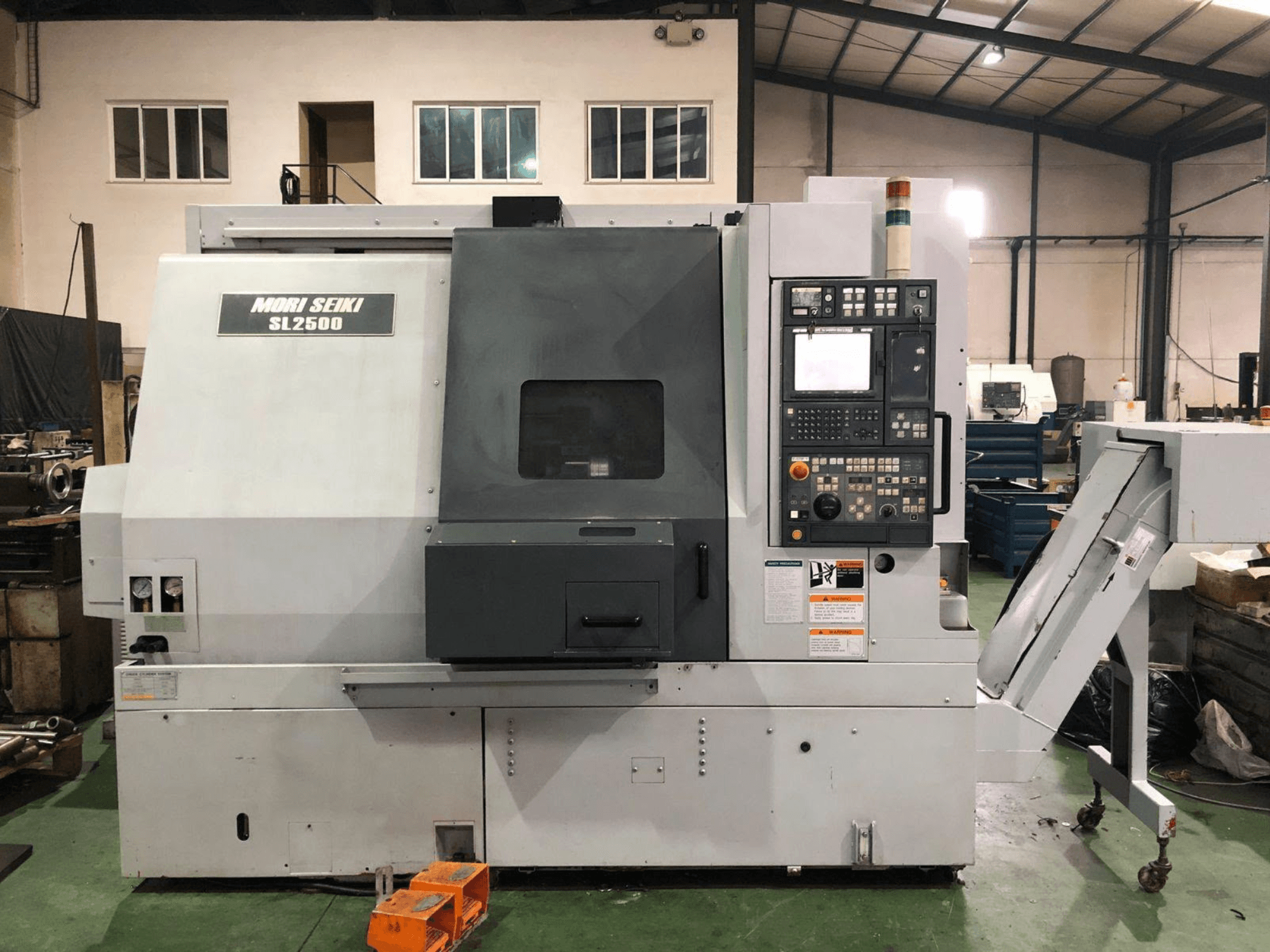 DMG Mori Seiki SL 2500 Y turn-mill centre, side view with control panel and chip conveyor visible.