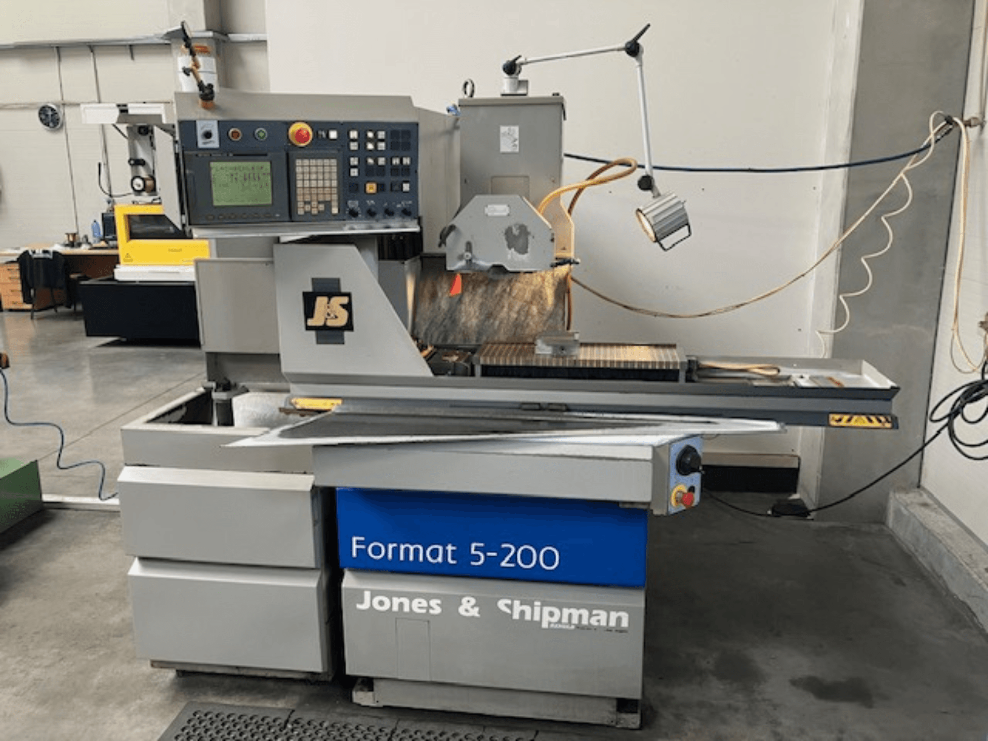 Surface grinding machine Jones & Shipman Format 5-200 in side view, featuring control panel, grinding wheel, and work table.
