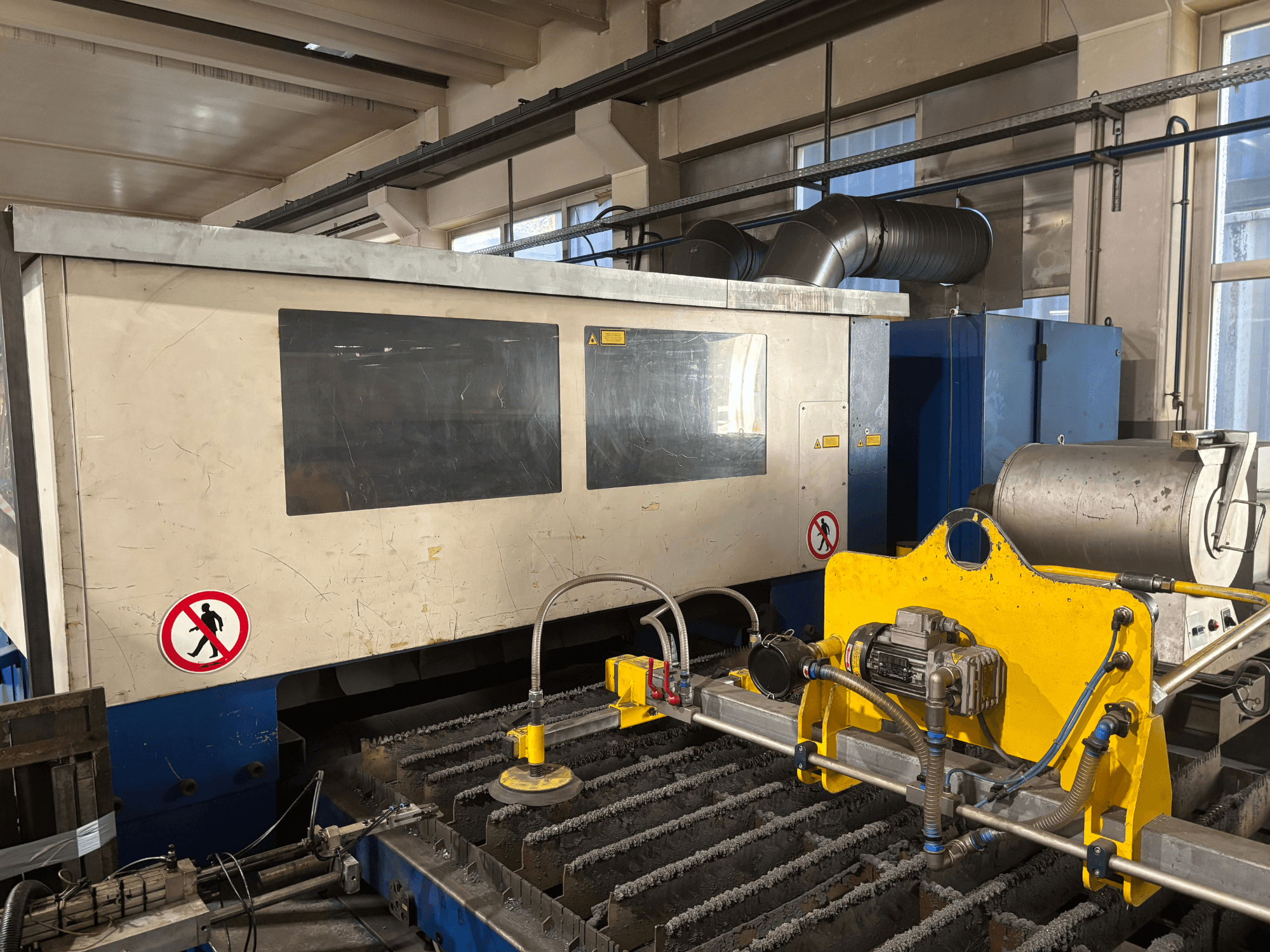 TRUMPF Trumatic L3030 CO2 laser cutting machine, front view showcasing control interface and cutting surface details.