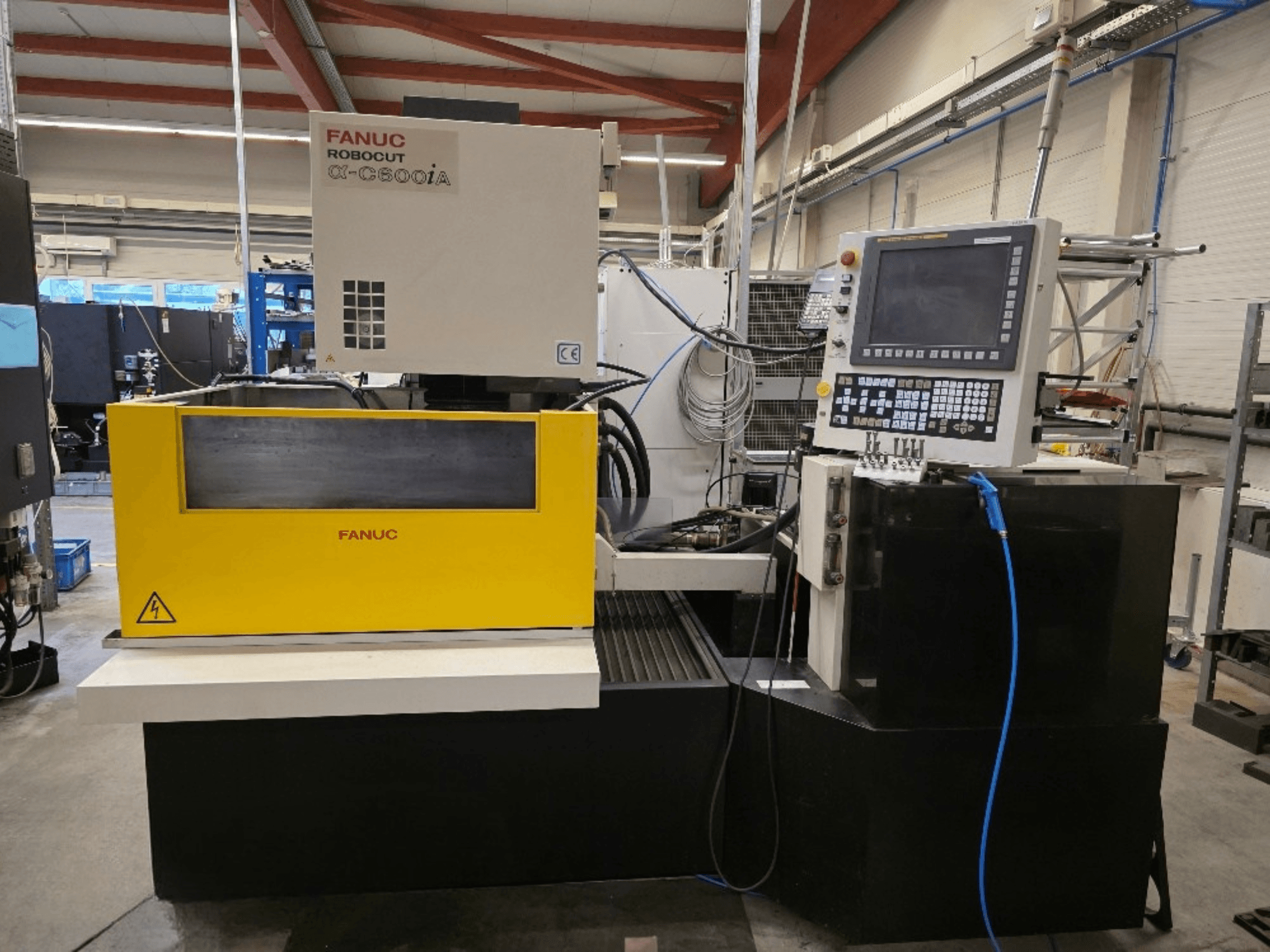 FANUC Robocut α-C600iA wire-cut machine, front view, featuring a yellow control panel and digital display.