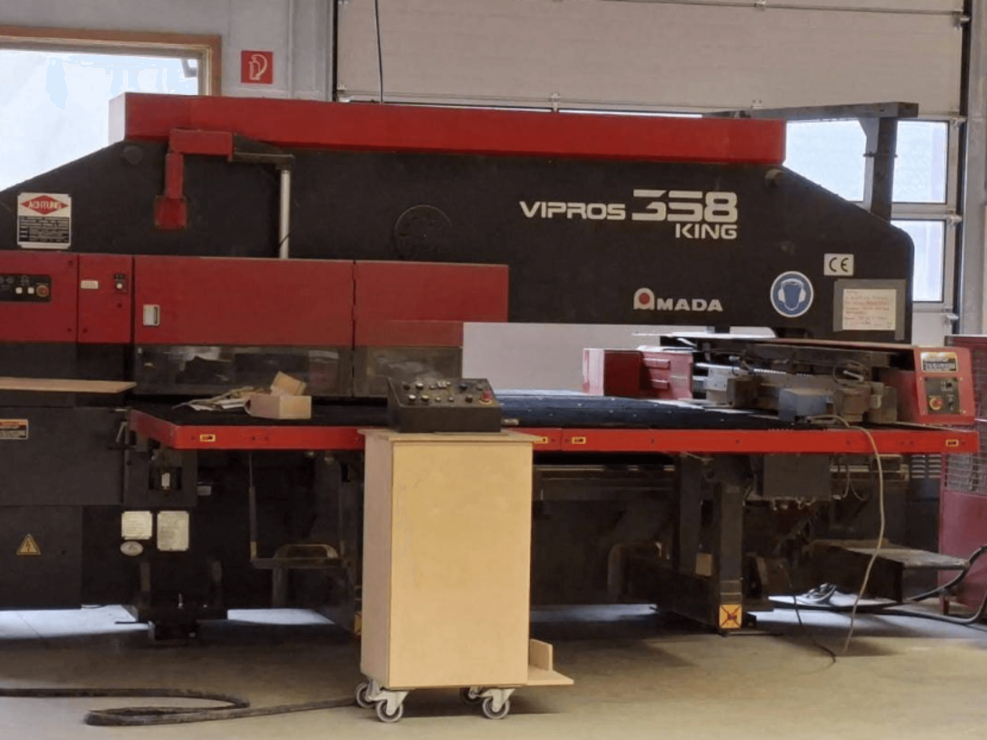 CNC Punch Press AMADA VIPROS 358 KING in side view, featuring control panel and tool storage area.