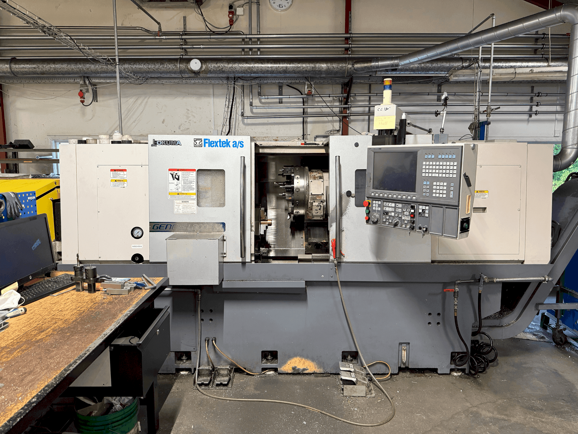 Front view of Okuma Genos L300E-M with FMB Turbo 8-80 machine