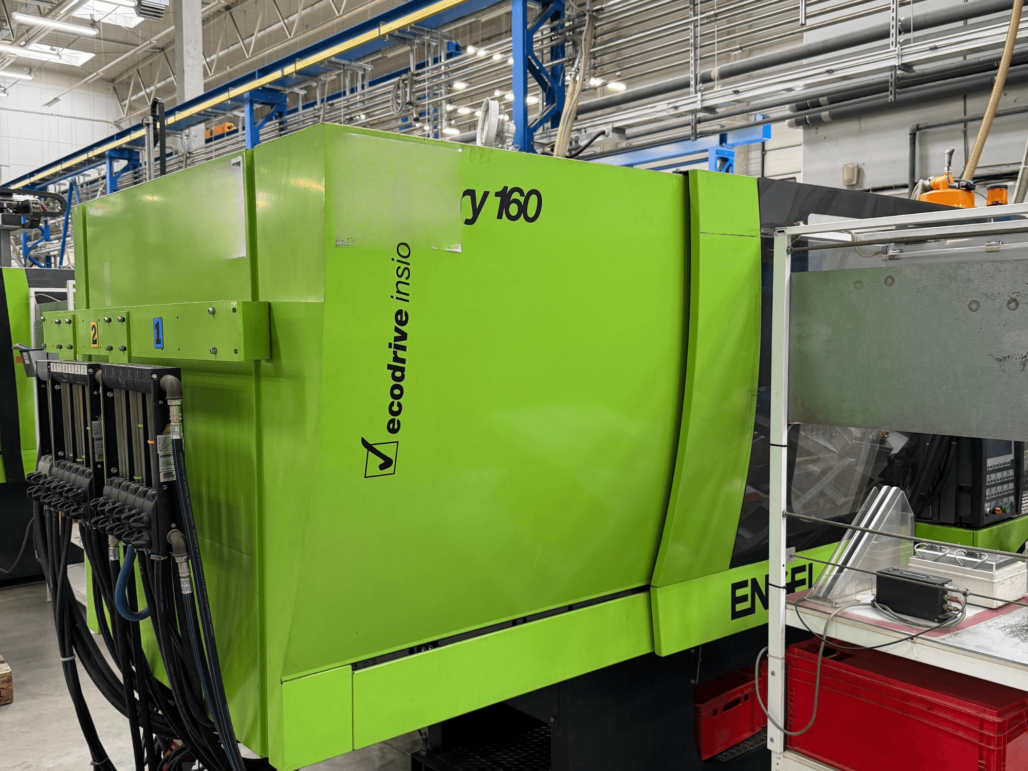 Engel Victory 500/160 tech hydraulic injection moulding machine in green, side view showing control panel and ecodrive feature.