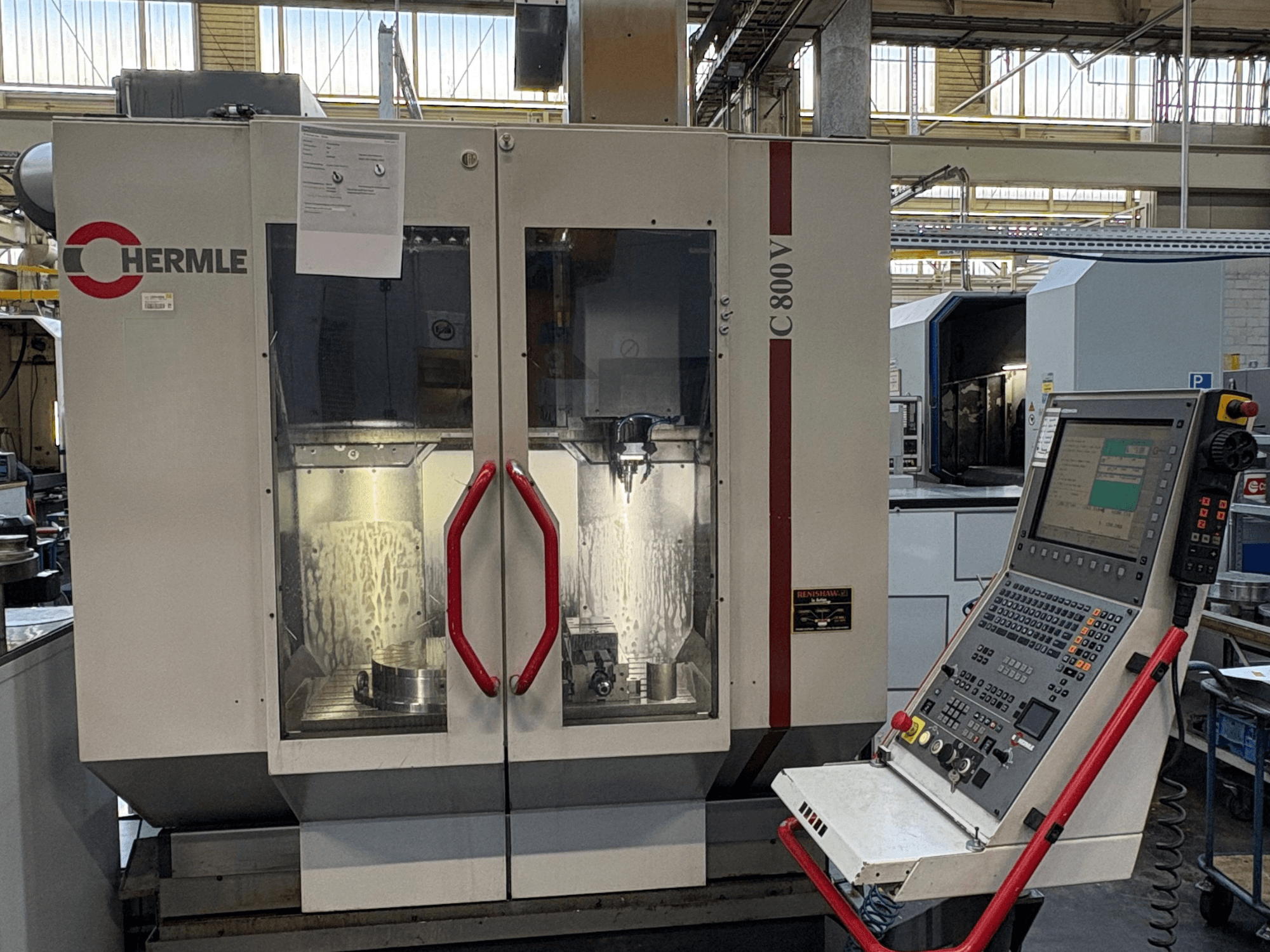 HERMLE C 800 V vertical machining centre, front view, with red-handled doors and control panel on the right.