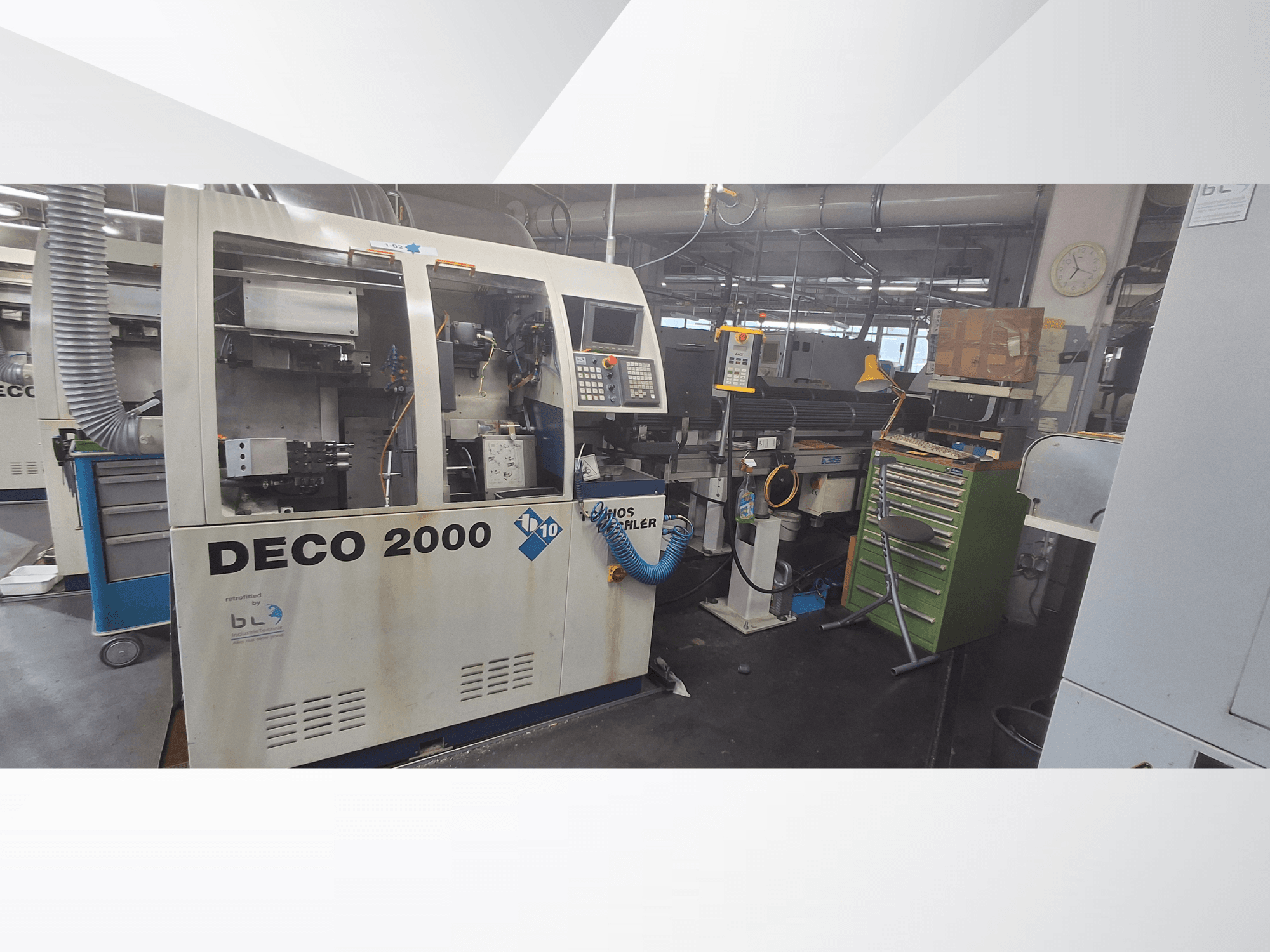 Swiss Type Turning Machine TORNOS DECO 2000-10, front view, showing control panel and loading area in a workshop setting.