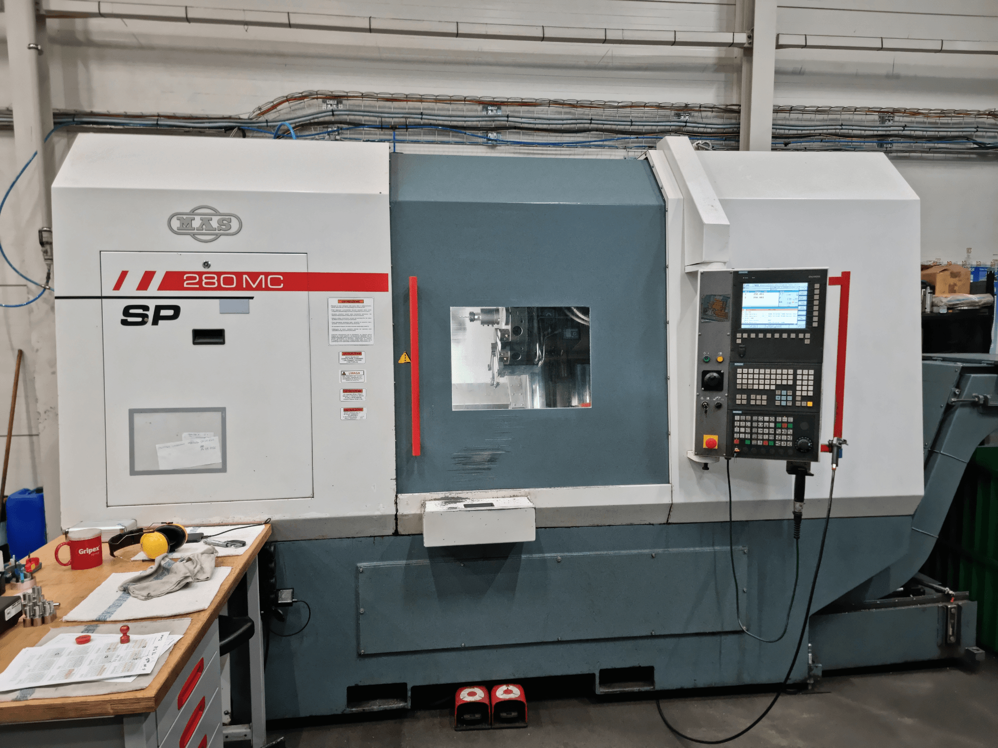 KOVOSVIT MAS SP 280 MC horizontal turning machine in a front view, featuring control panel and operational window.