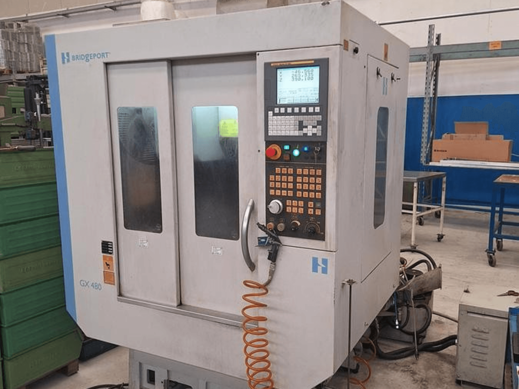 Bridgeport GX 480 vertical machining centre in front view, featuring a control panel, dual glass doors, and flexible hose.