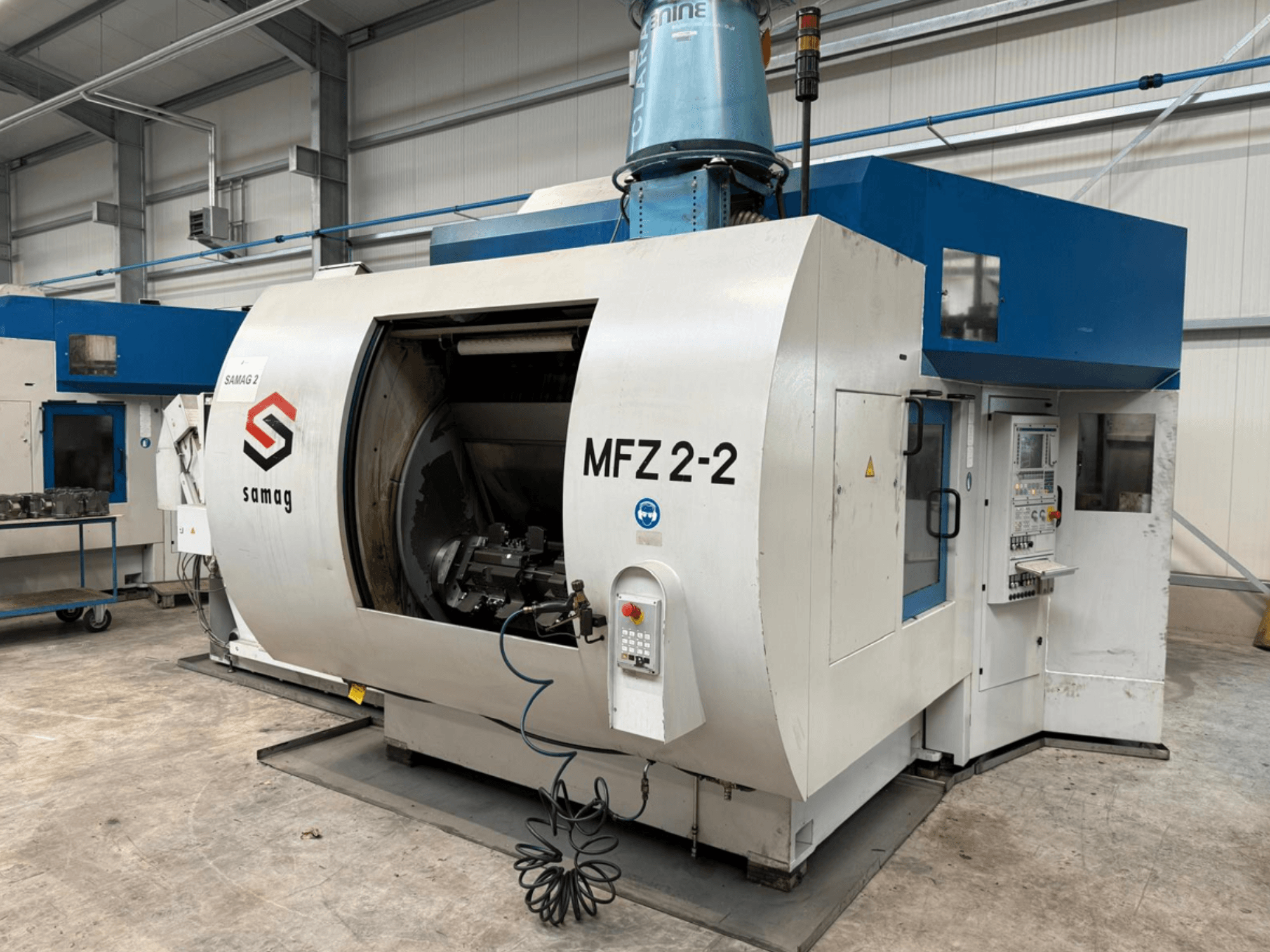 Samag MFZ 2-2 milling machine in side view, showcasing a large, open chamber and control panel with various buttons and knobs.