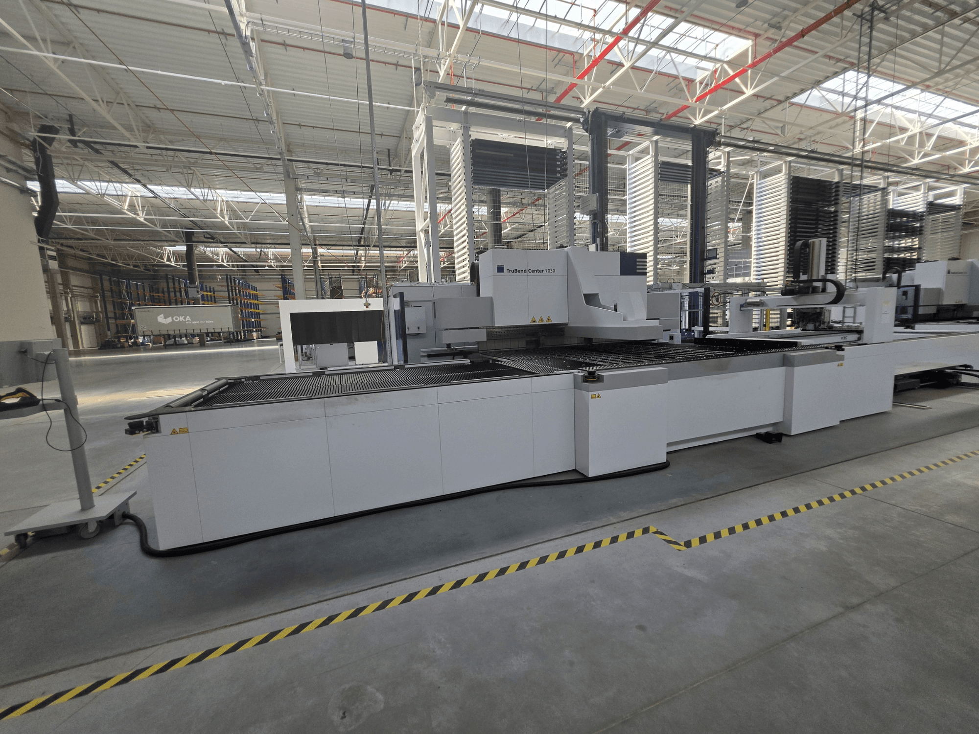 TRUMPF TruBend Center 7030 folding machine, side view, showcasing the working area and controls in a spacious workshop.
