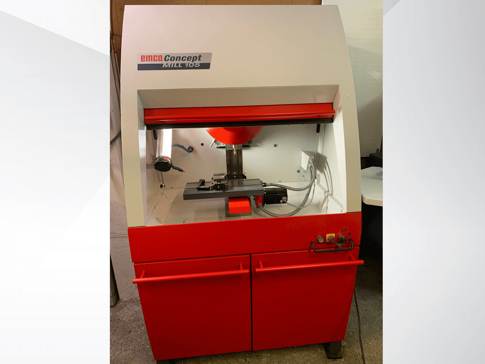EMCO Concept MILL 105, front view of a compact milling machine with a red base, features a cutting tool and bright lighting.