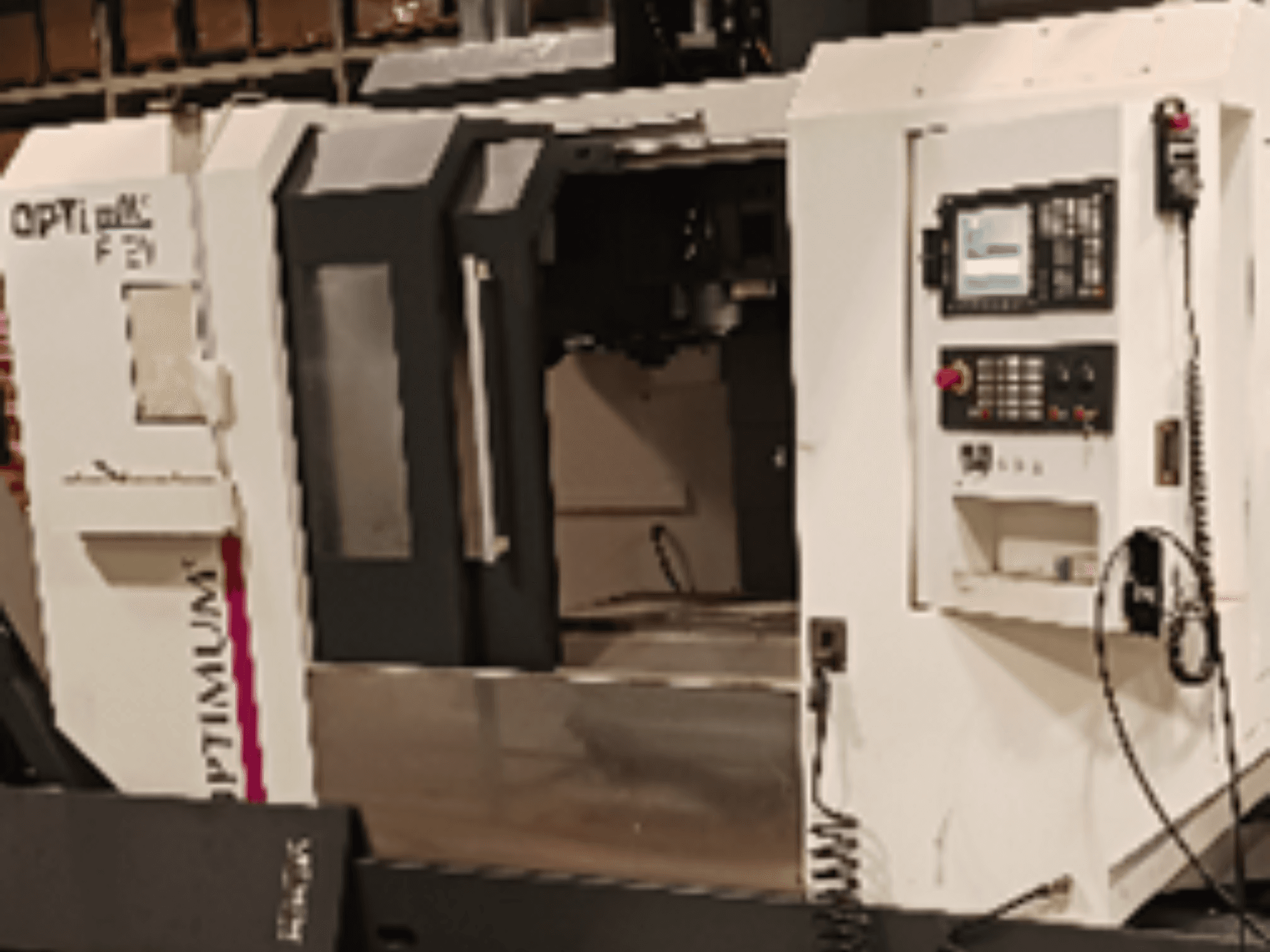 Optimum F310 vertical machining centre in front view, featuring a control panel and accessible work area.