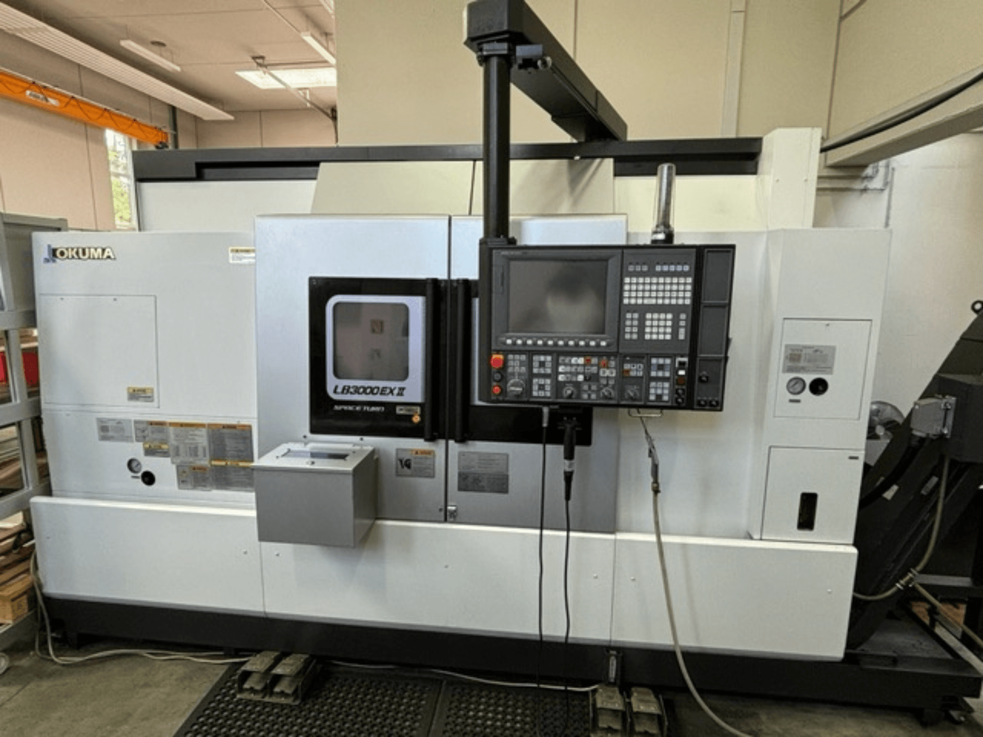 Okuma LB 3000 EXII horizontal turning machine, front view showing control panel and operational features.