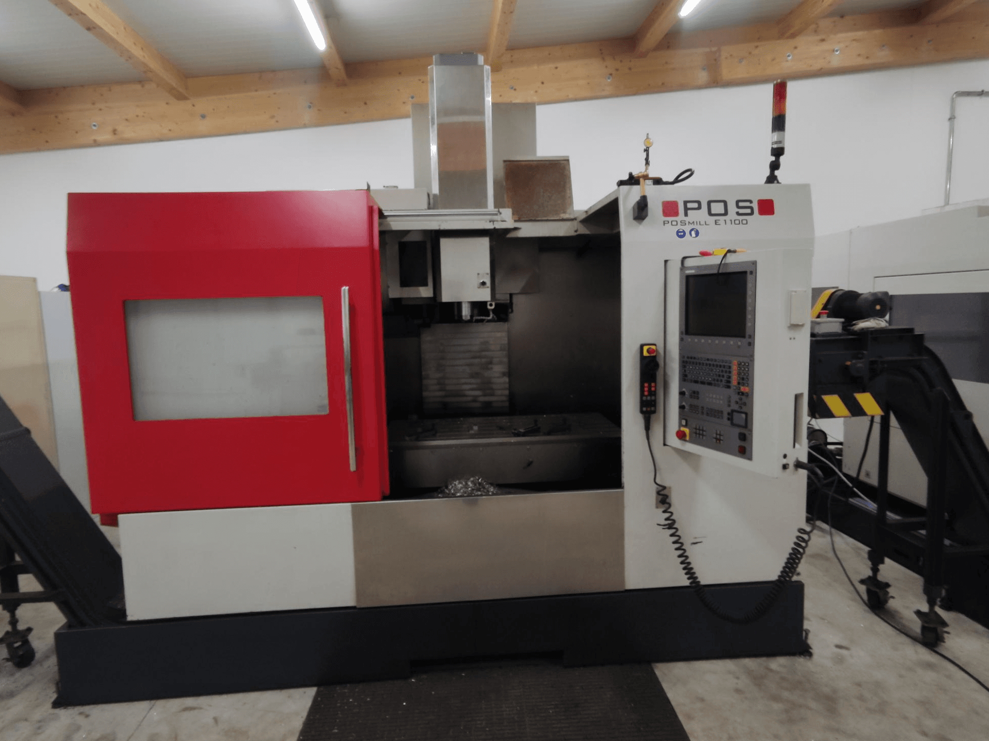 POS POSMILL E1100 CNC milling machine in front view with a red enclosure, control panel, and safety light on top.