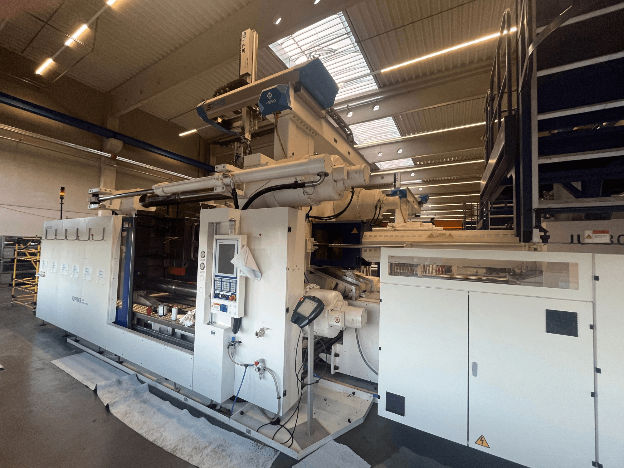 Front view of an Autefa textile machine, featuring control panel, components, and industrial setting.